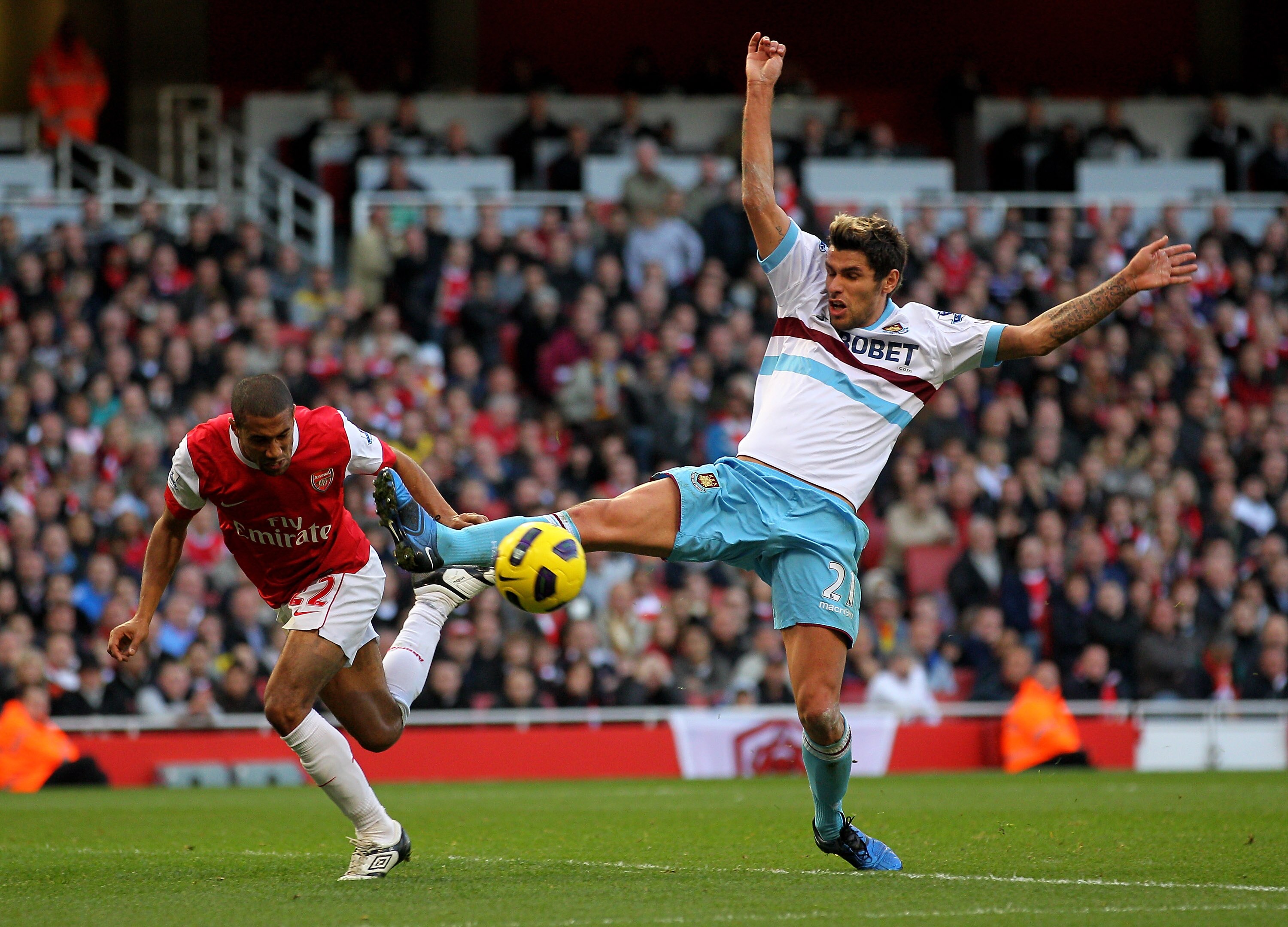 LONDON, ENGLAND - OCTOBER 30: Gael Clichy of Arsenal and Valon Behrami of West Ham challenge for the ball during the Barclays Premier League match between Arsenal and West Ham United at Emirates Stadium on October 30, 2010 in London, England.  (Photo by C