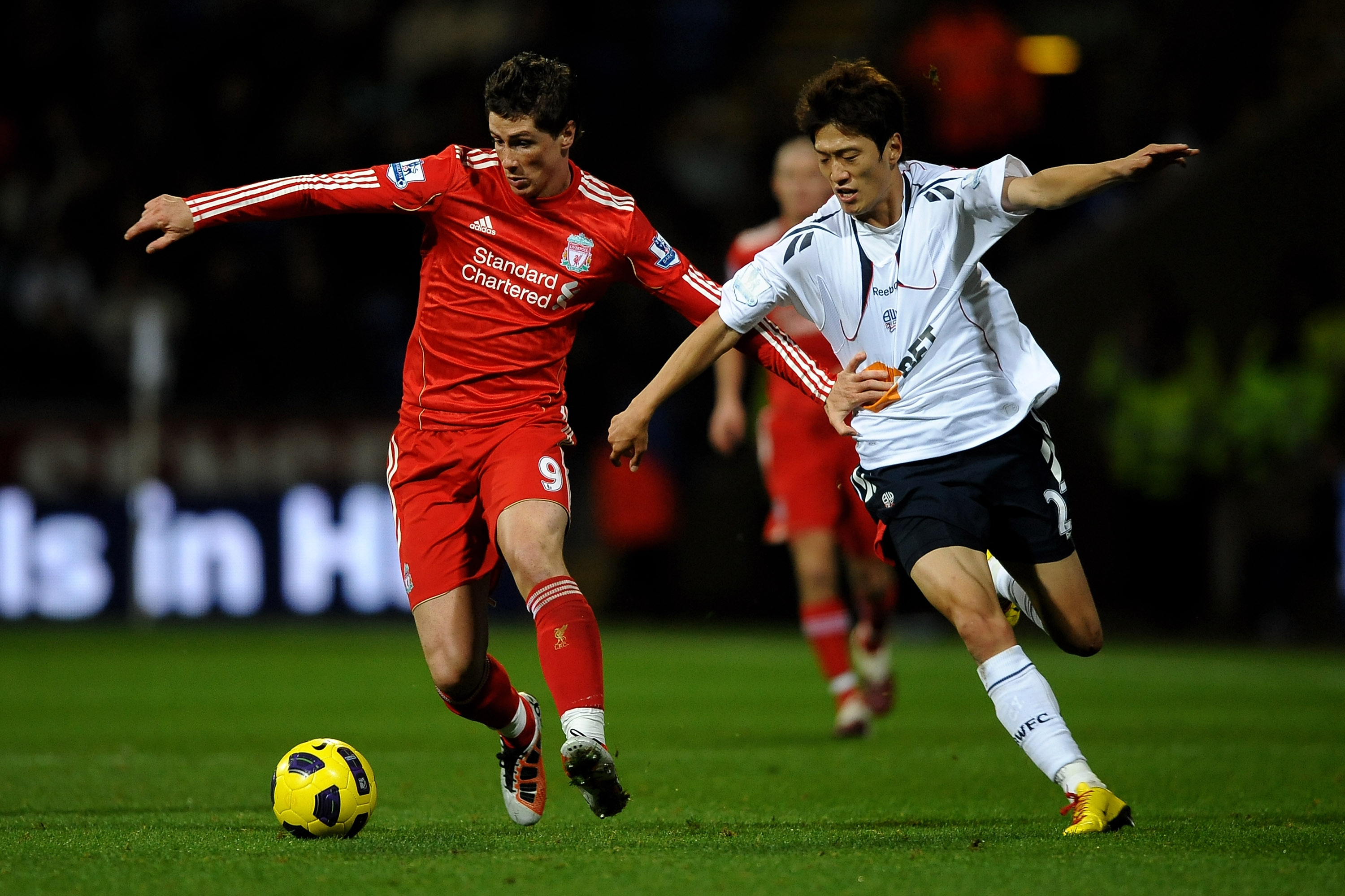 BOLTON, ENGLAND - OCTOBER 31:  Fernando Torres of Liverpool tussles for posession with Chung Yong Lee of Bolton Wanderers during the Barclays Premier League match between Bolton Wanderers and Liverpool at the Reebok Stadium on October 31, 2010 in Bolton,