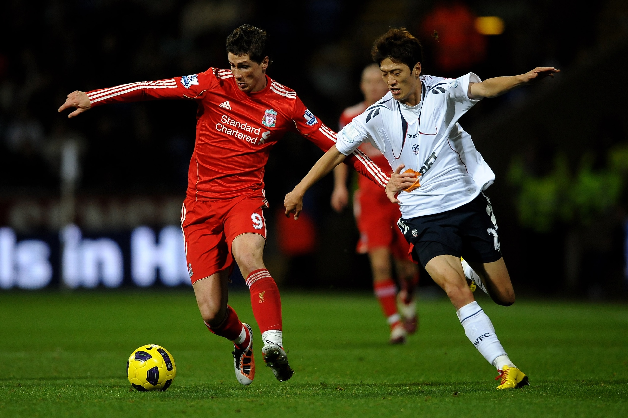 BOLTON, ENGLAND - OCTOBER 31:  Fernando Torres of Liverpool tussles for posession with Chung Yong Lee of Bolton Wanderers during the Barclays Premier League match between Bolton Wanderers and Liverpool at the Reebok Stadium on October 31, 2010 in Bolton,