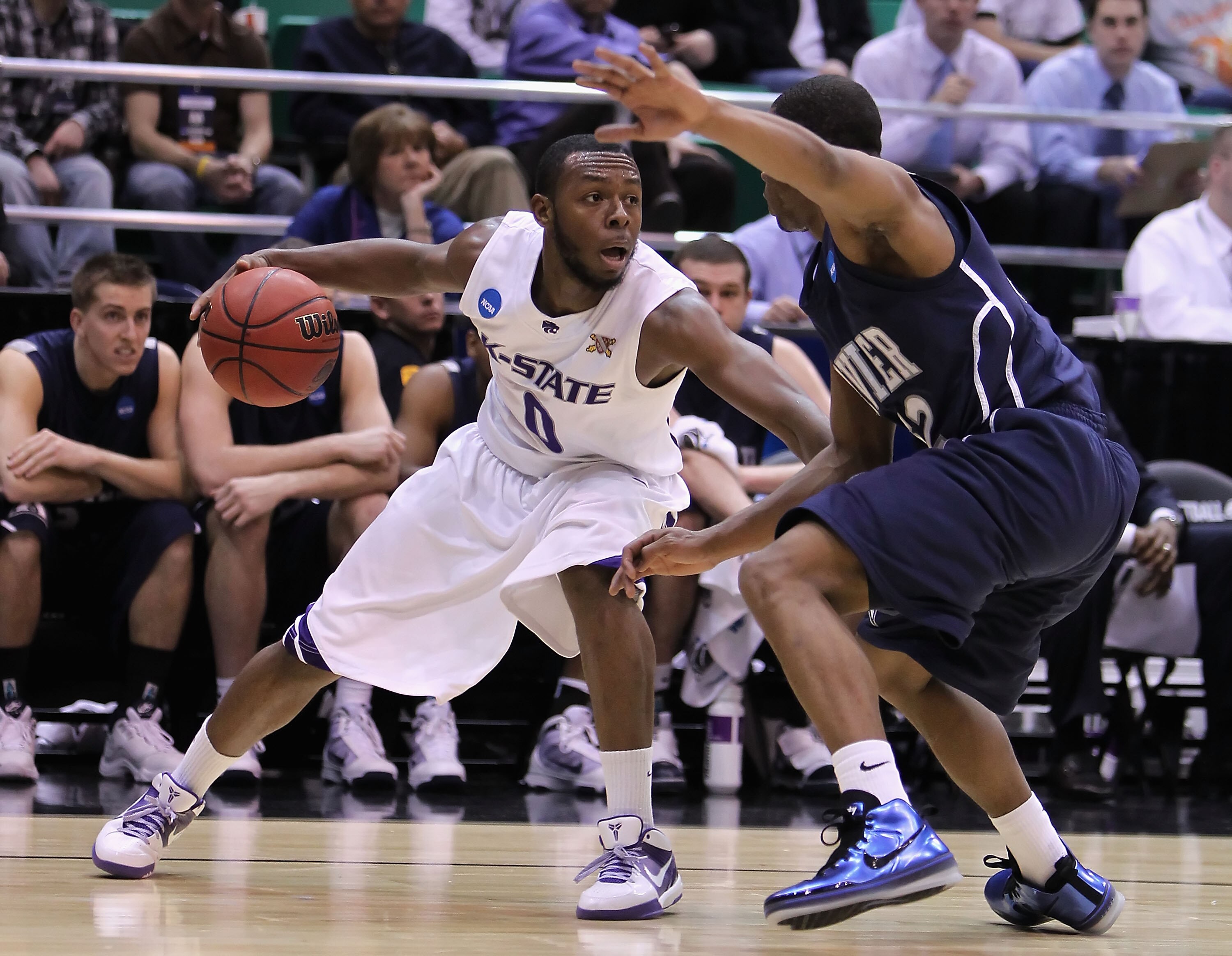 SALT LAKE CITY - MARCH 25:  Jacob Pullen #0 of the Kansas State Wildcats handles the ball under pressure from Terrell Holloway #52 of the Xavier Musketeers during the west regional semifinal of the 2010 NCAA men's basketball tournament at the Energy Solut