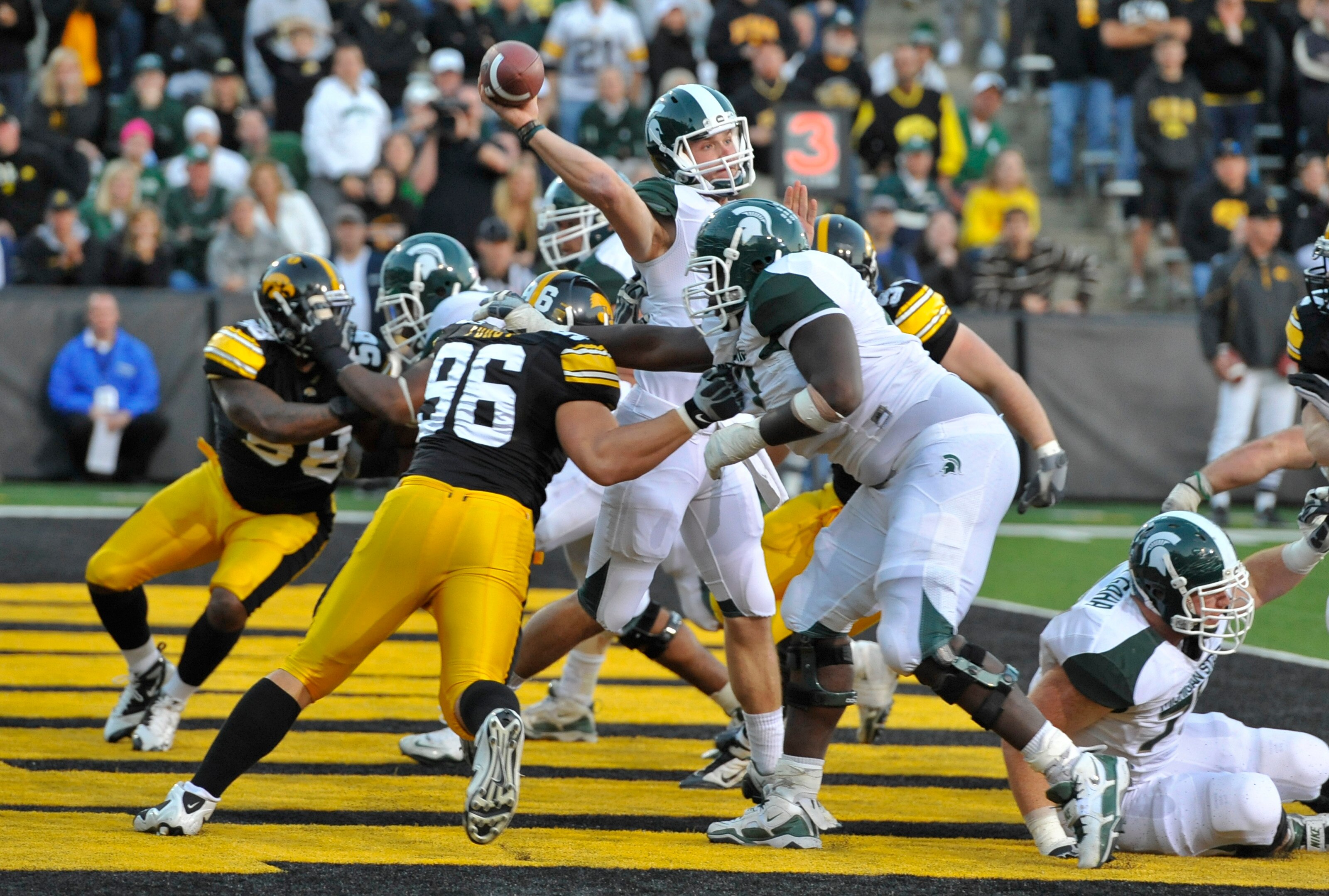 IOWA CITY, IA - OCTOBER 30:  Backup Quarterback Andrew Maxwell #10 of the Michigan State Spartans throws under pressure from Defensive lineman Joe Forgy #96 of the Iowa Hawkeyes during the second half of play at Kinnick Stadium on October 30, 2010 in Iowa