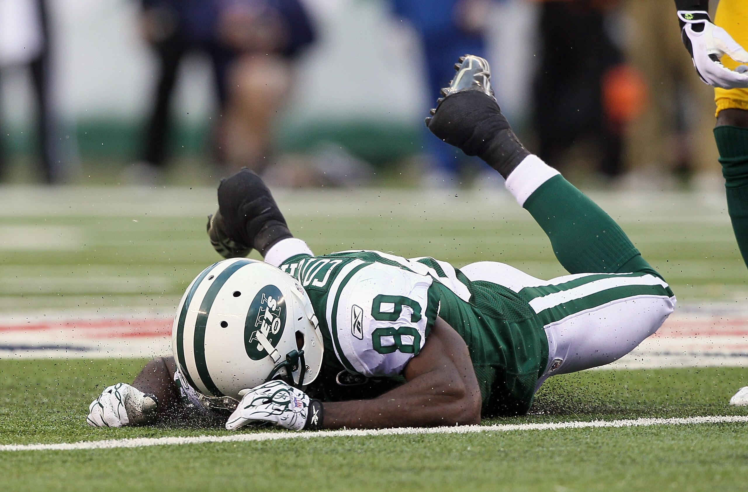 EAST RUTHERFORD, NJ - OCTOBER 31: Jerricho Cotchery #89 of the New York Jets lays on the field after missing a pass against the Green Bay Packers in the fourth quarter on October 31, 2010 at the New Meadowlands Stadium in East Rutherford, New Jersey. The