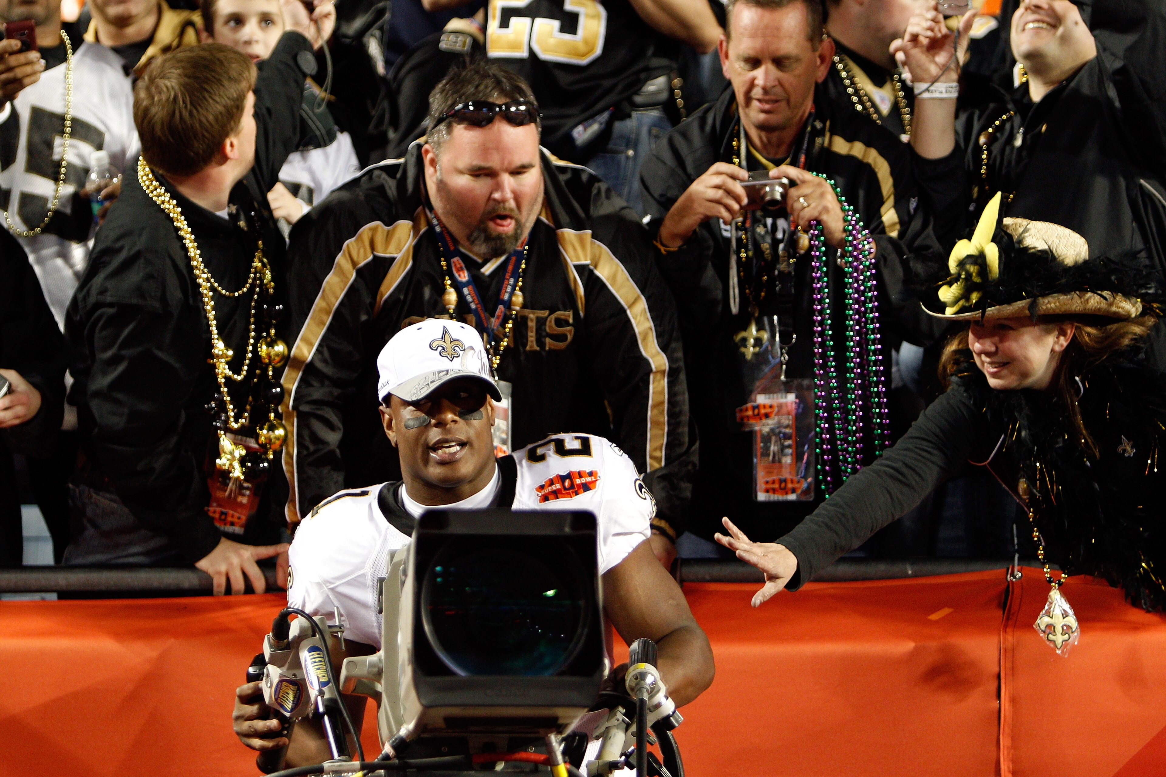 MIAMI GARDENS, FL - FEBRUARY 07:  Mike Bell # 23 of the New Orleans Saints takes control of a TV camera after defeating the Indianapolis Colts during Super Bowl XLIV on February 7, 2010 at Sun Life Stadium in Miami Gardens, Florida.  (Photo by Chris Grayt