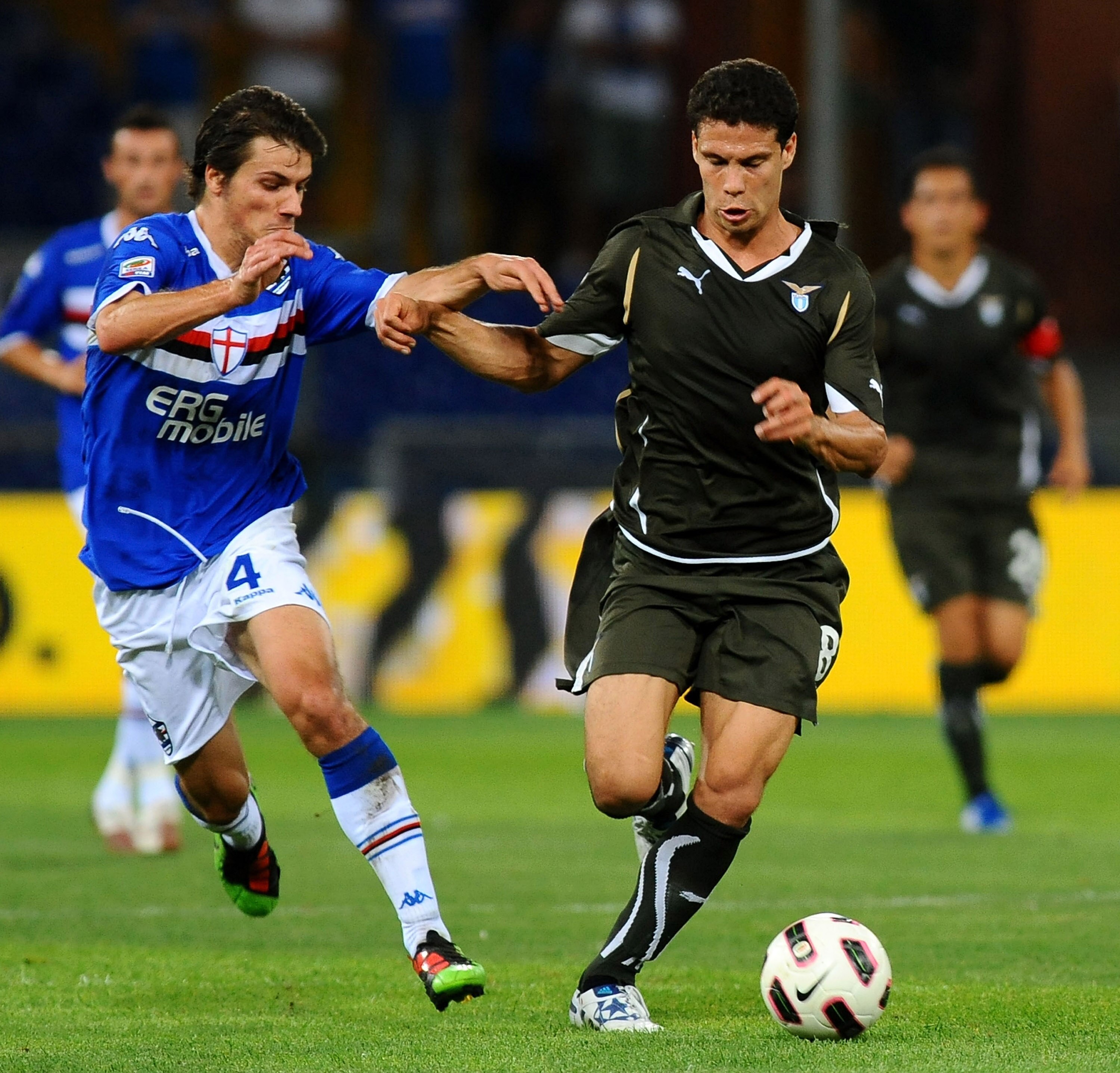 GENOA, ITALY - AUGUST 29: Daniele Dessena of UC Sampdoria battles for the ball against Hernanes de Carvalho Andrade Lima Anderson of SS Lazio during the Serie A match between UC Sampdoria and SS  Lazio at Stadio Luigi Ferraris on August 29, 2010 in Genoa,