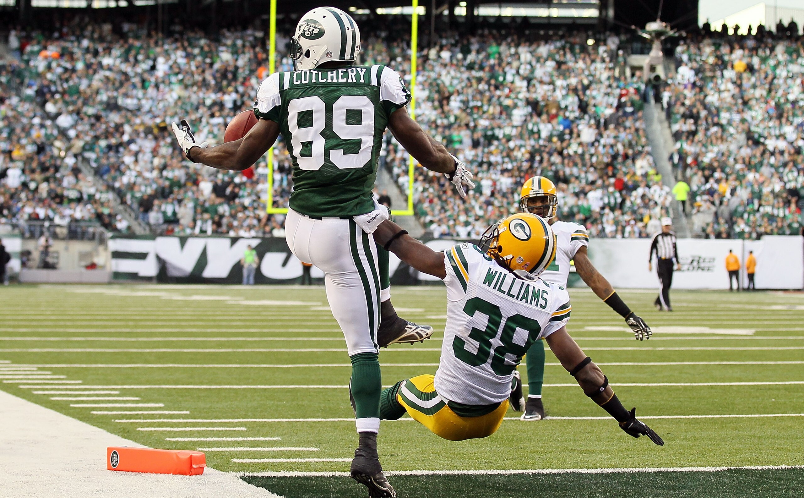 EAST RUTHERFORD, NJ - OCTOBER 31: Jerricho Cotchery #89 of the New York Jets can not hold onto a pass as he is defended by Tramon Williams #38 of the Green Bay Packers late in the fourth quarter on October 31, 2010 at the New Meadowlands Stadium in East R