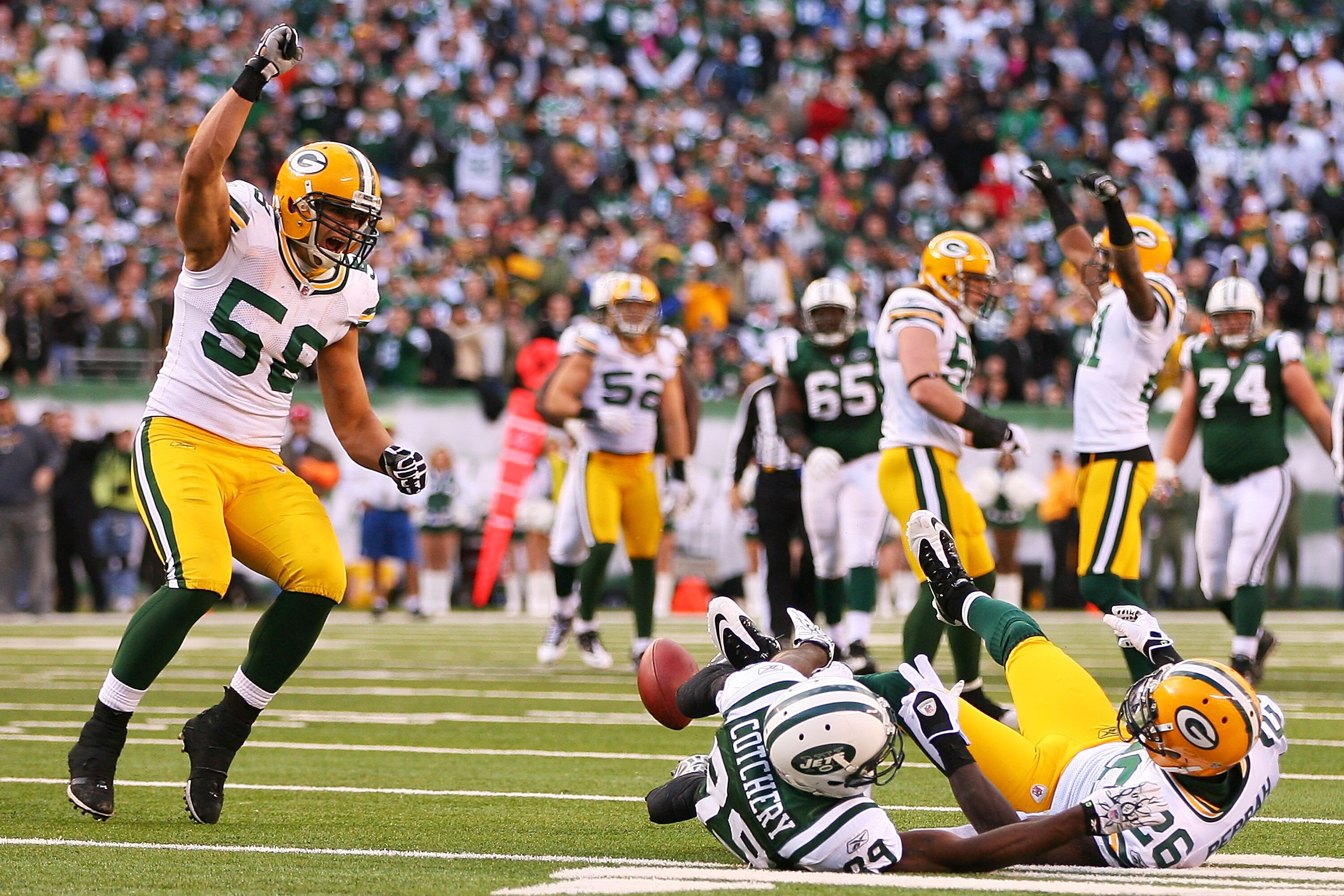 EAST RUTHERFORD, NJ - OCTOBER 31:  Frank Zombo #58 (L) of the Green Bay Packers celebrates after Jerricho Cotchery #89 of the New York Jets misses a catch in the fourth quarter on October 31, 2010 at the New Meadowlands Stadium in East Rutherford, New Jer