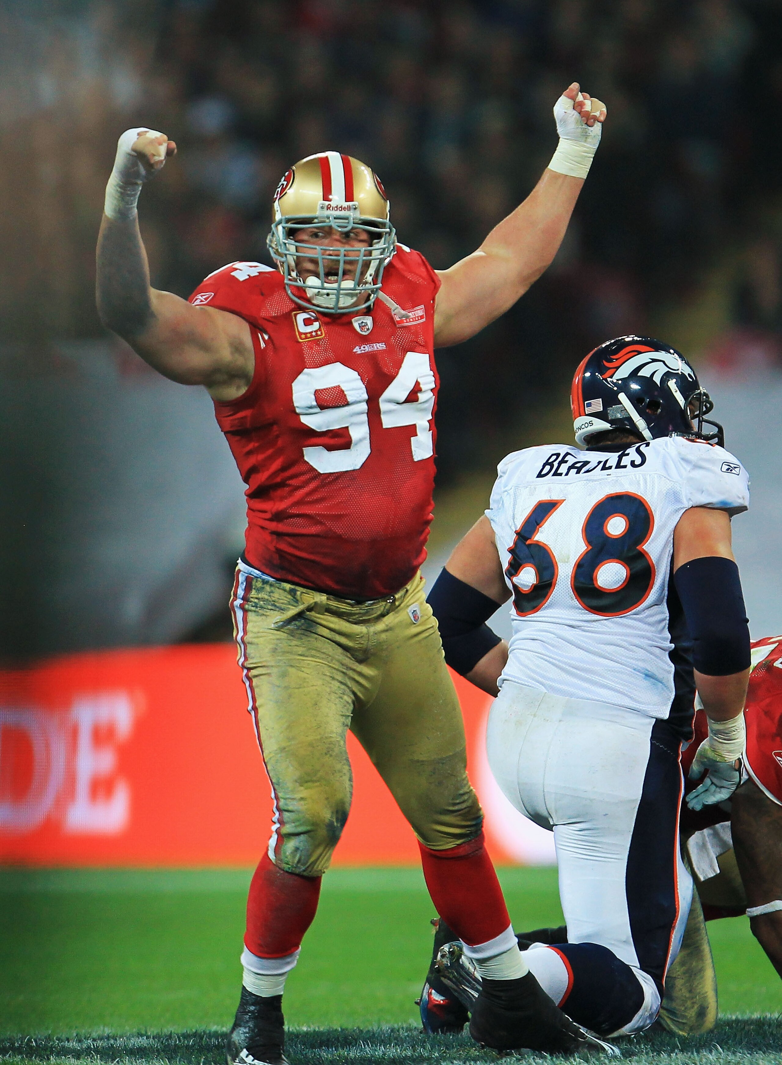 LONDON, ENGLAND - OCTOBER 31:  Justin Smith #94 of San Francisco 49ers celebrates sacking Kyle Orton the Denver Broncos Quarterback during the NFL International Series match between Denver Broncos and San Francisco 49ers at Wembley Stadium on October 31,