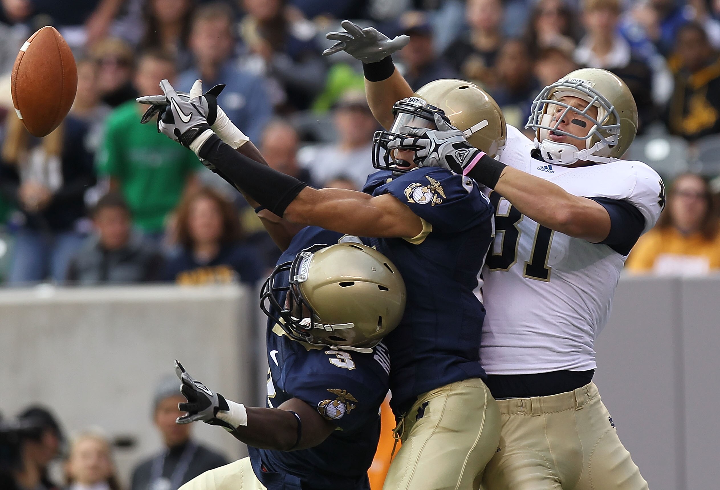 EAST RUTHERFORD, NJ - OCTOBER 23: (L-R) De'Von Richardson #3 and Kevin Edwards #15 of the Navy Midshipmen break up the pass against John Goodman #81 of the Notre Dame Fighting Irish at New Meadowlands Stadium on October 23, 2010 in East Rutherford, New Je
