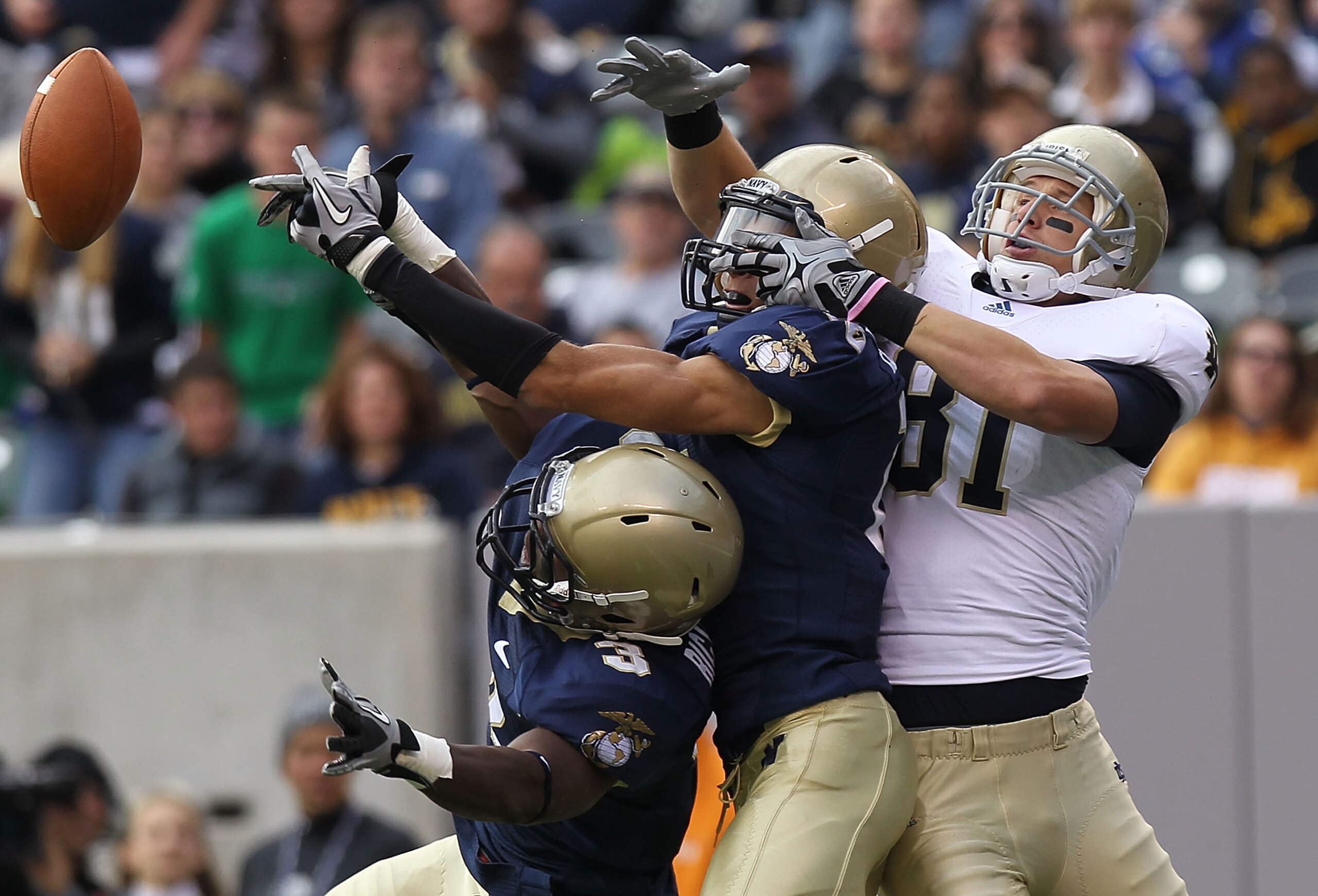 EAST RUTHERFORD, NJ - OCTOBER 23: (L-R) De'Von Richardson #3 and Kevin Edwards #15 of the Navy Midshipmen break up the pass against John Goodman #81 of the Notre Dame Fighting Irish at New Meadowlands Stadium on October 23, 2010 in East Rutherford, New Je