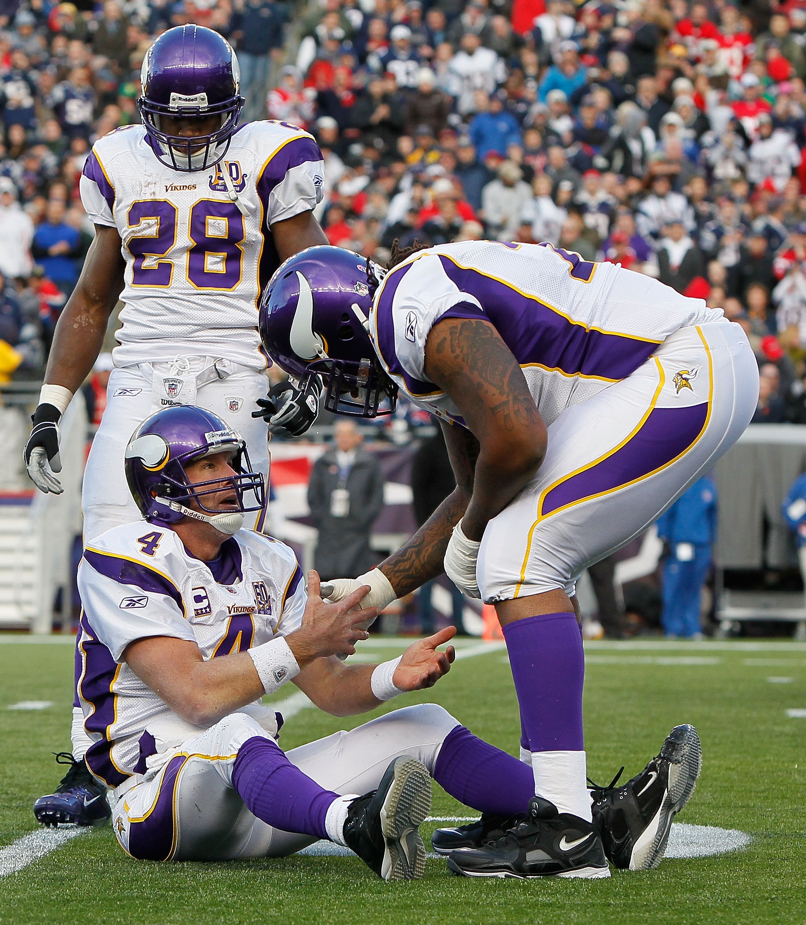 FOXBORO, MA - OCTOBER 31:  Brett Favre #4 of the Minnesota Vikings is helped up after being knocked down in the first half against the New England Patriots at Gillette Stadium on October 31, 2010 in Foxboro, Massachusetts. (Photo by Jim Rogash/Getty Image