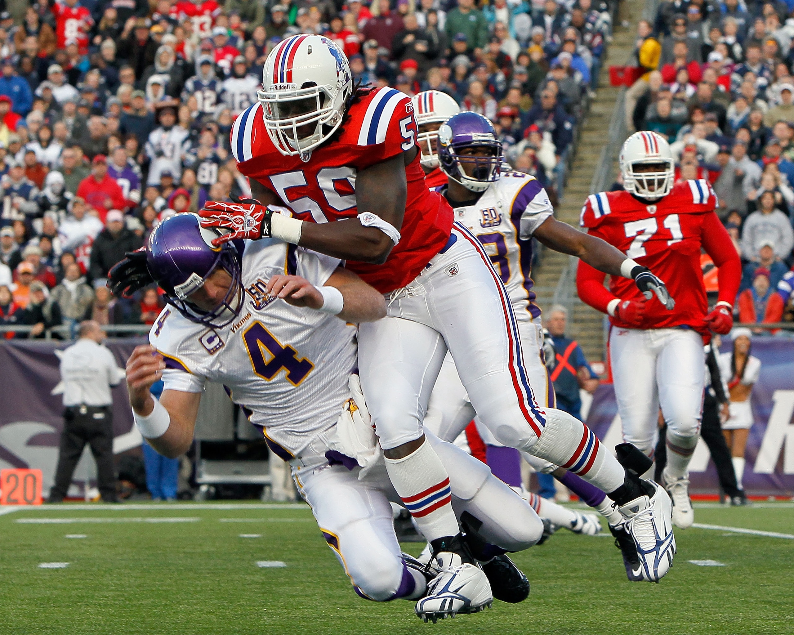 FOXBORO, MA - OCTOBER 31:  Brett Favre #4 of the Minnesota Vikings is knocked down by Gary Guyton #59 of the New England Patriots in the first half at Gillette Stadium on October 31, 2010 in Foxboro, Massachusetts. (Photo by Jim Rogash/Getty Images)