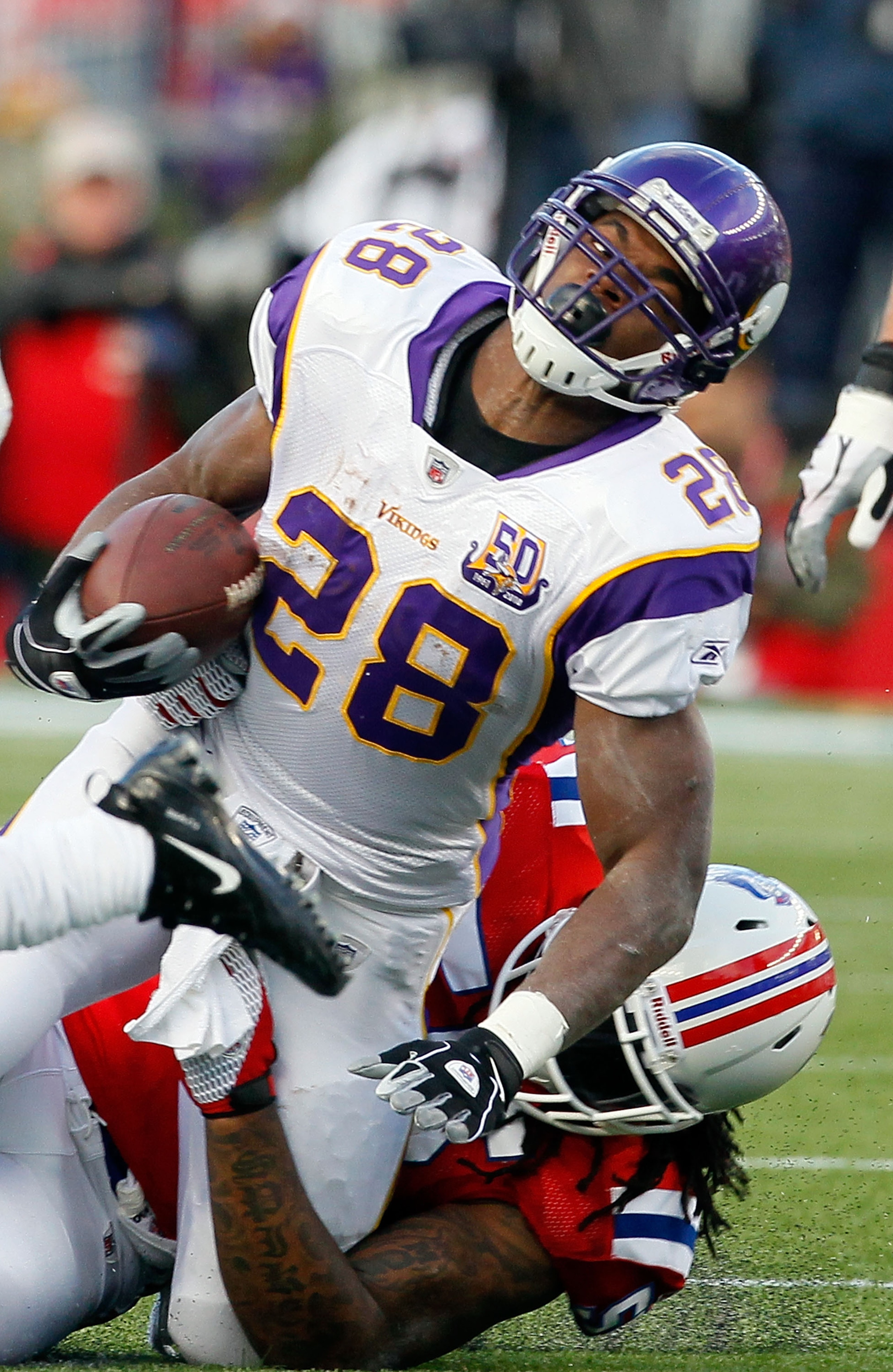 FOXBORO, MA - OCTOBER 31:  Adrian Peterson #28 the Minnesota Vikings is stopped against the New England Patriots at Gillette Stadium on October 31, 2010 in Foxboro, Massachusetts. (Photo by Jim Rogash/Getty Images)