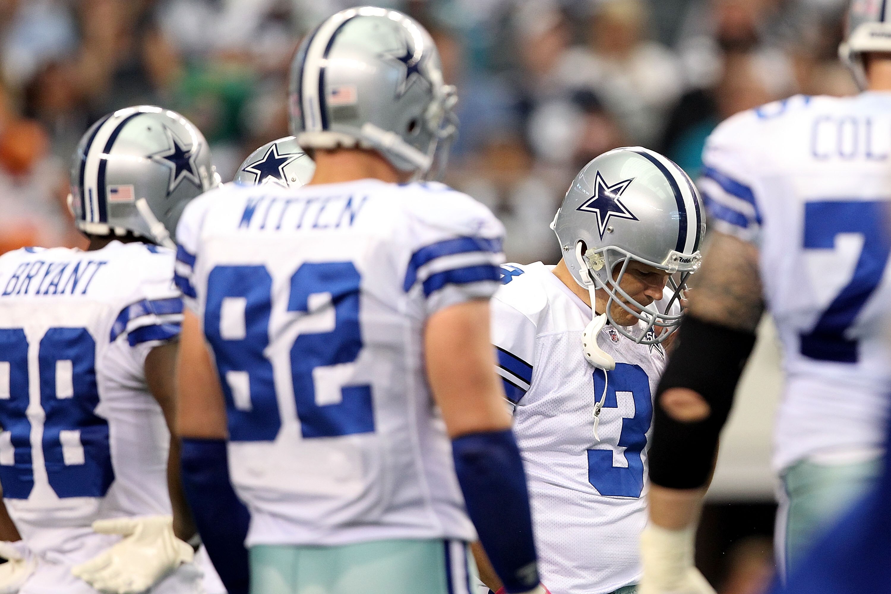ARLINGTON, TX - OCTOBER 31:  Quarterback Jon Kitna #3 of the Dallas Cowboys stands in the huddle with his head down against the Jacksonville Jaguars at Cowboys Stadium on October 31, 2010 in Arlington, Texas.  (Photo by Chris Chambers/Getty Images)