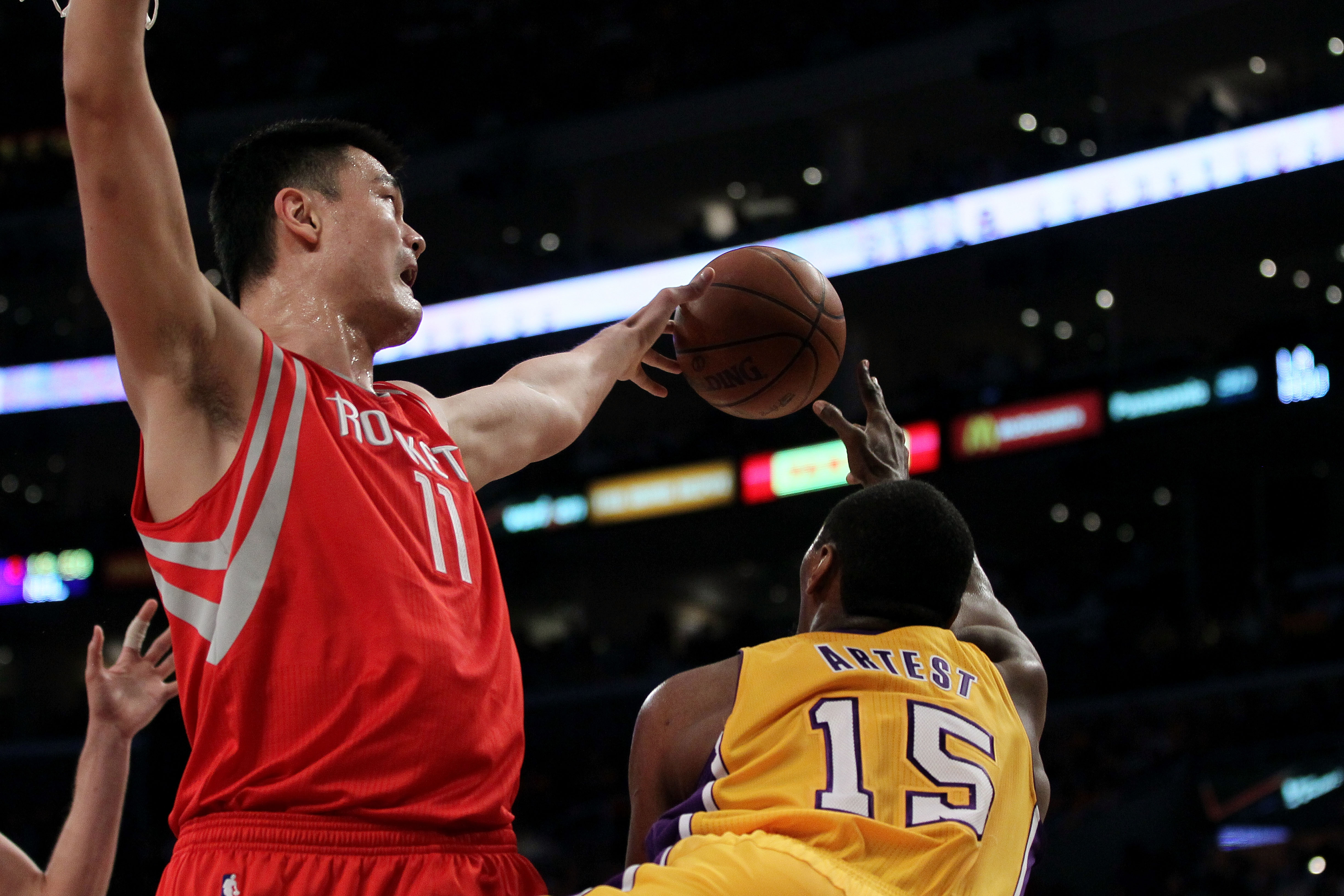 LOS ANGELES, CA - OCTOBER 26:  Yao Ming #11 of the Houston Rockets blocks a pass by Ron Artest #15 of the Los Angeles Lakers during their NBA game at Staples Center on October 26, 2010 in Los Angeles, California. NOTE TO USER: User expressly acknowledges