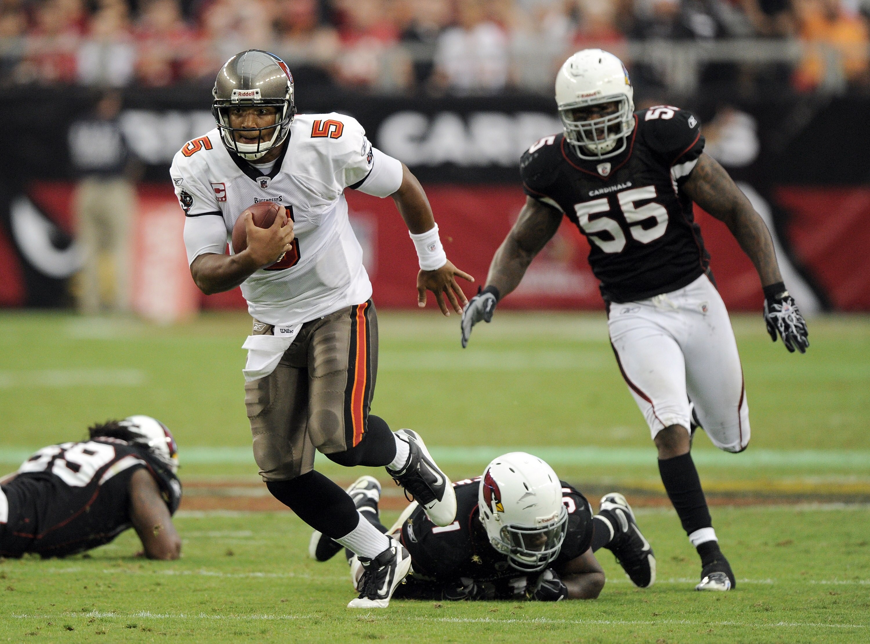 GLENDALE, AZ - OCTOBER 31:  Josh Freeman #5 of the Tampa Bay Buccaneers scrambles away from Joey Porter #55, Kenny Iwebema #91 and Will Davis #59 of the Arizona Cardinals during the third quarter at University of Phoenix Stadium on October 31, 2010 in Gle
