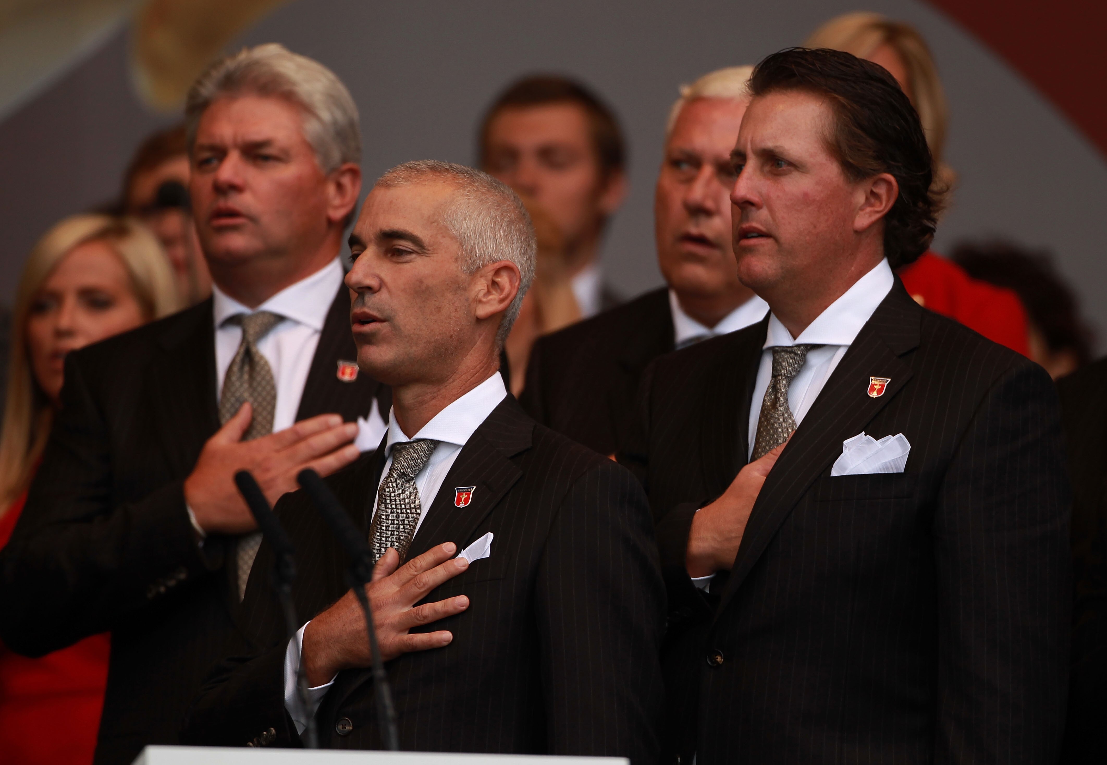NEWPORT, WALES - SEPTEMBER 30:  USA Team Captain Corey Pavin and Phil Mickelson (R) stand for their national anthem during the Opening Ceremony prior to the 2010 Ryder Cup at the Celtic Manor Resort on September 30, 2010 in Newport, Wales.  (Photo by Andr