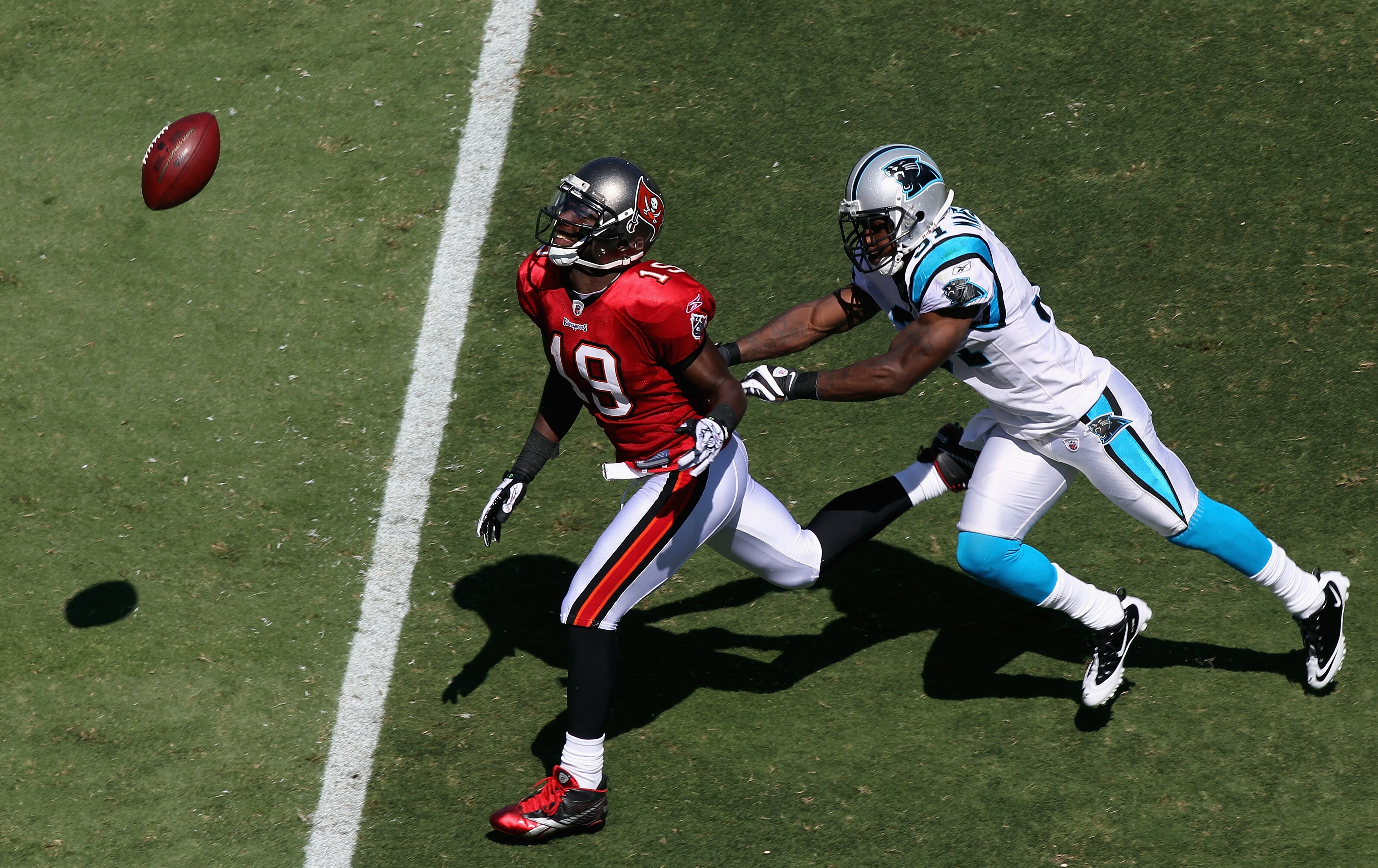 CHARLOTTE, NC - SEPTEMBER 19:  Mike Williams #19 of the Tampa Bay Buccaneers misses a catch as Richard Marshall #31 of the Carolina Panthers tracks him down during their game at Bank of America Stadium on September 19, 2010 in Charlotte, North Carolina.