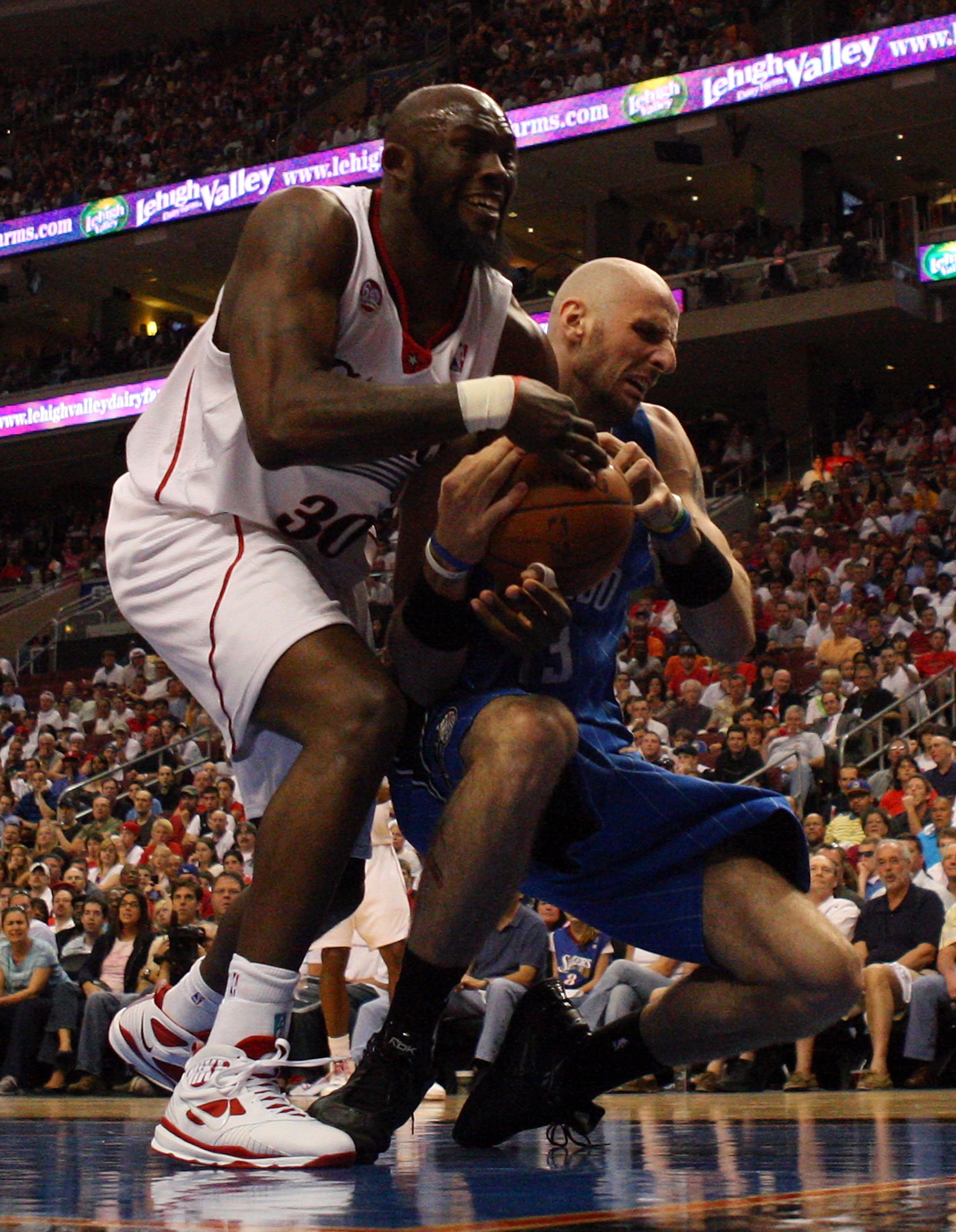 PHILADELPHIA - APRIL 26:  Reggie Evans #33 of the Philadelphia 76ers battles for the ball against Marcin Gortat #13 of the Orlando Magic during Game Four of the Eastern Conference Quarterfinals during the 2009 NBA Playoffs at the Wachovia Center on April