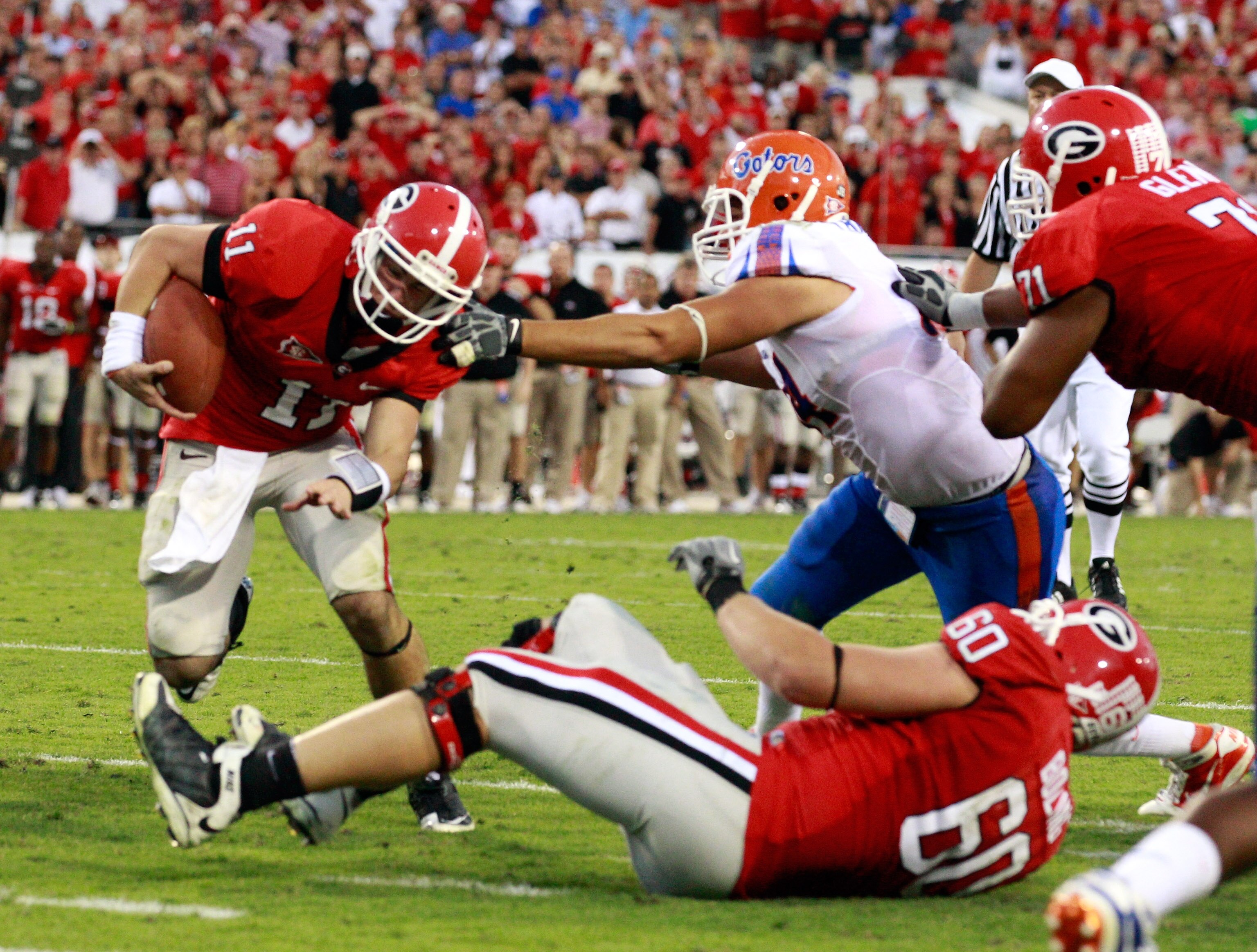 JACKSONVILLE, FL - OCTOBER 30:  Aaron Murray #11 of the Georgia Bulldogs runs past Justin Trattou #94 of the Florida Gators for a touchdown during the game at EverBank Field on October 30, 2010 in Jacksonville, Florida.  (Photo by Sam Greenwood/Getty Imag