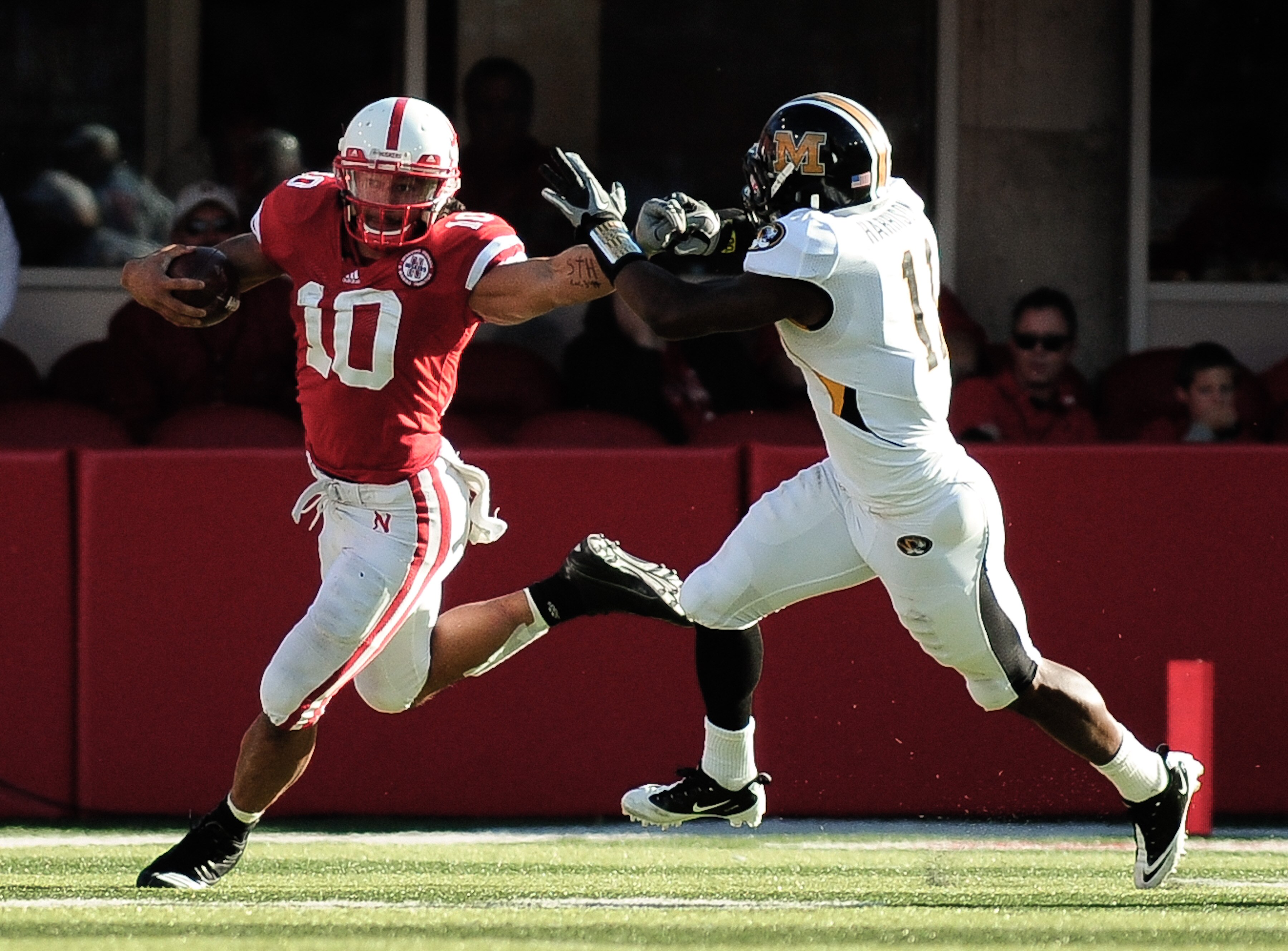 LINCOLN, NE - OCTOBER 30: Running back Roy Helu Jr. #10 of the Nebraska Cornhuskers slips safety Jarrell Harrison #11of the Missouri Tigers during first half action of their game at Memorial Stadium on October 30, 2010 in Lincoln, Nebraska. Hellu Jr. brok