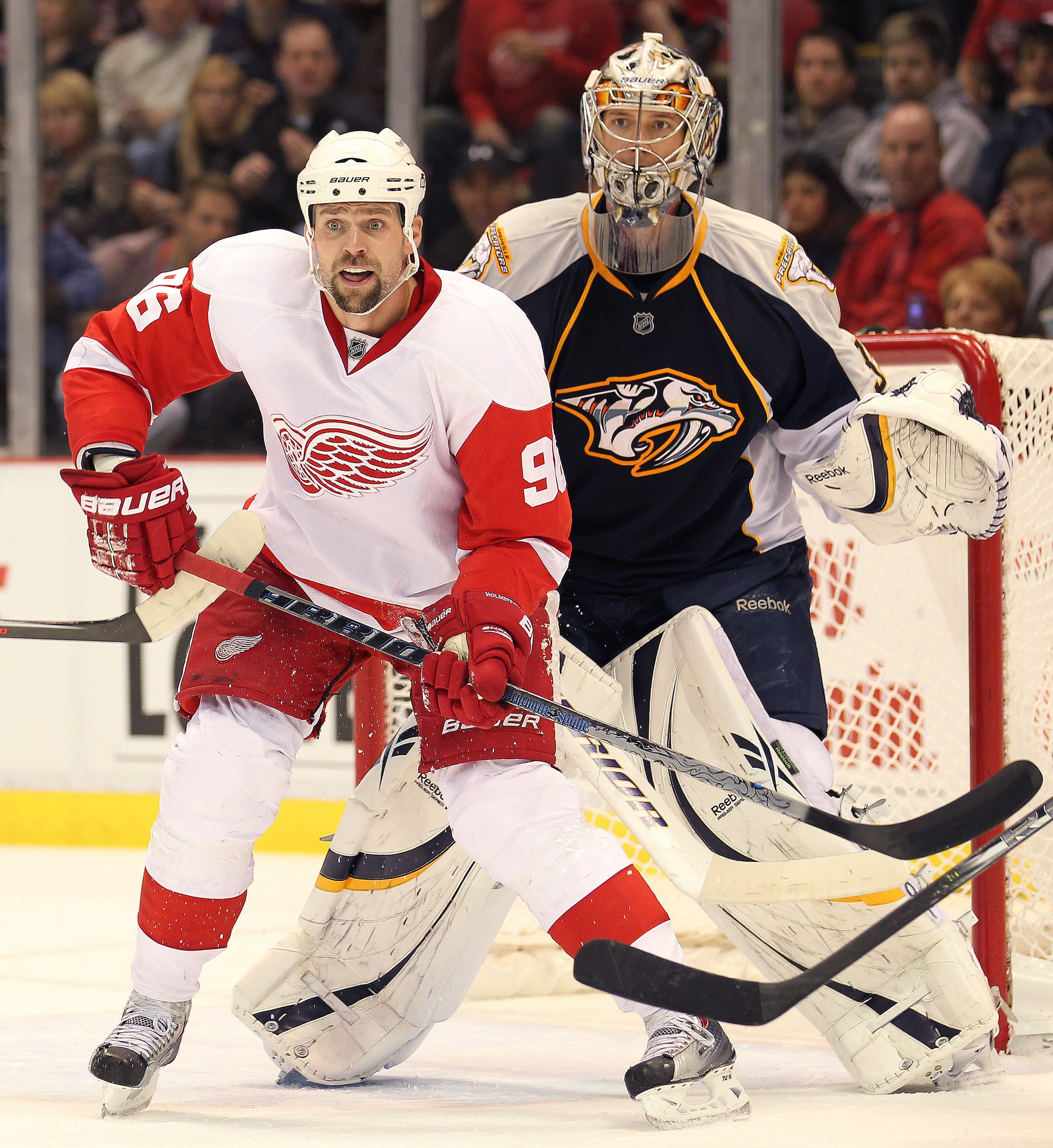 DETROIT - OCTOBER 30:  Tomas Holmstrom #96 of the Detroit Red Wings waits to tip a shot in front of Pekka Rinne #35 of the Nashville Predators in a game on October 30, 2010 at the Joe Louis Arena in Detroit , Michigan. The Wings defeated the Predators 5-2