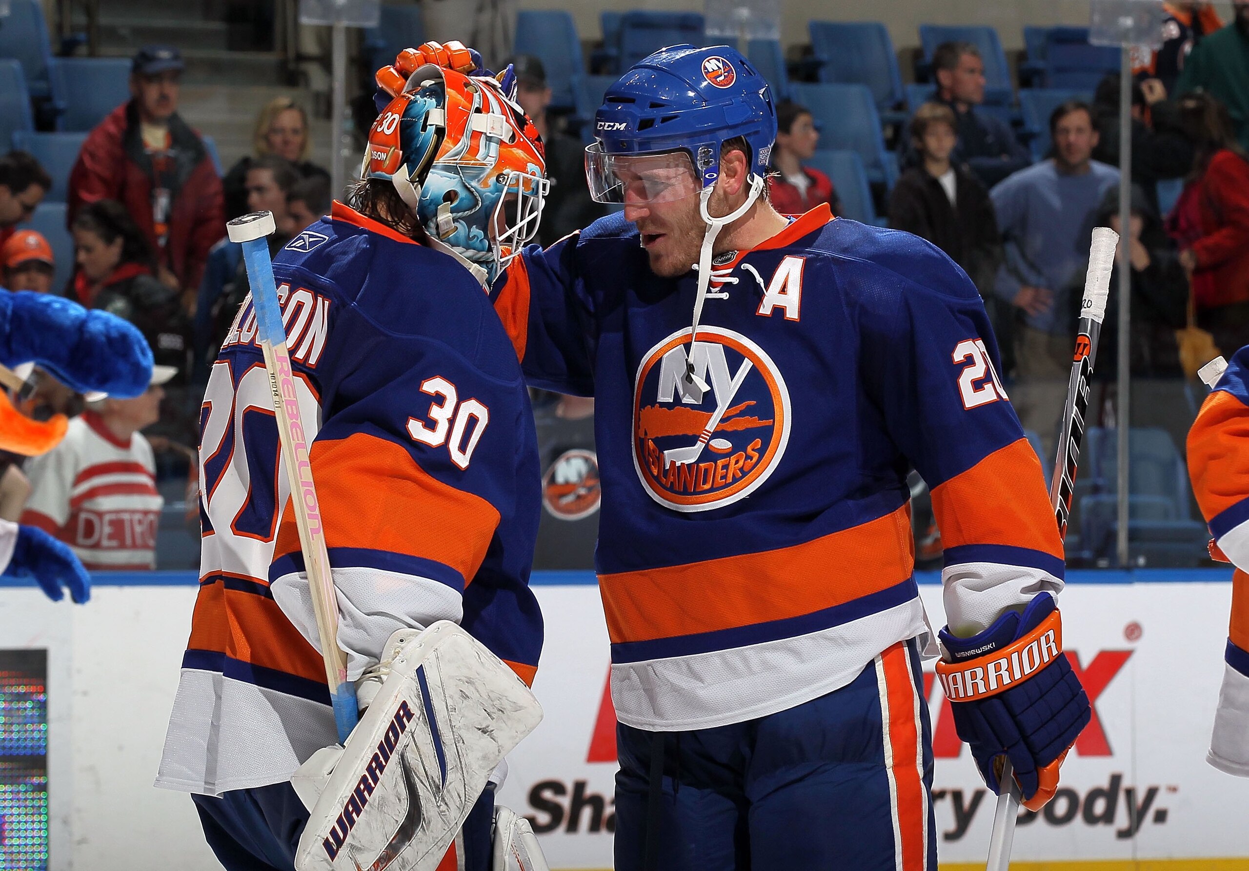 UNIONDALE, NY - OCTOBER 16:  James Wisniewski #20 and Dwayne Roloson #30 of the New York Islanders celebrate against the Colorado Avalanche on October 16, 2010 at Nassau Coliseum in Uniondale, New York.  (Photo by Jim McIsaac/Getty Images)