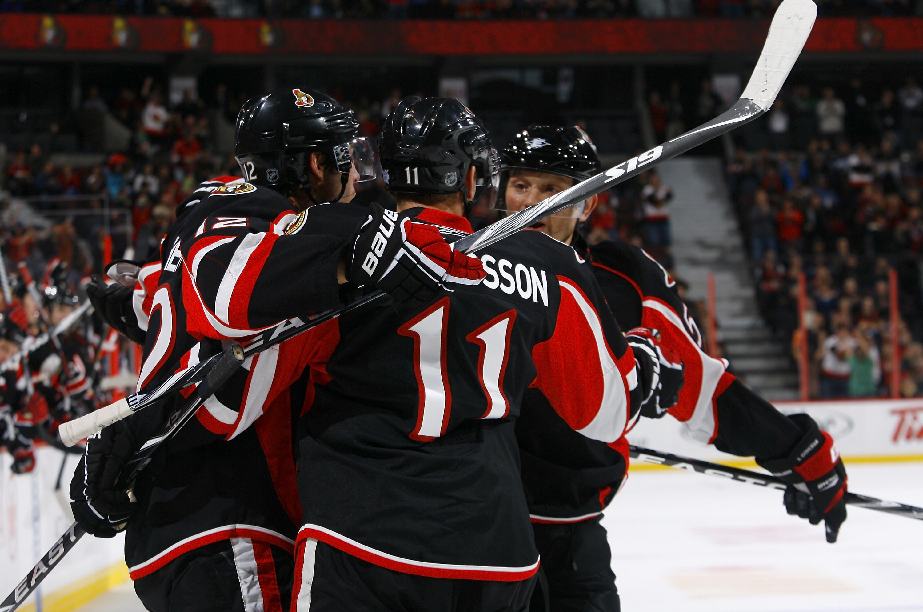 OTTAWA, ON - OCTOBER 28:  Mike Fisher #12 of the Ottawa Senators celebrates his goal agaisnt the Florida Panthers with teammates Daniel Alfredsson #11 and Sergei Gonchar #55 during a game at Scotiabank Place on October 28, 2010 in Ottawa, Ontario, Canada.