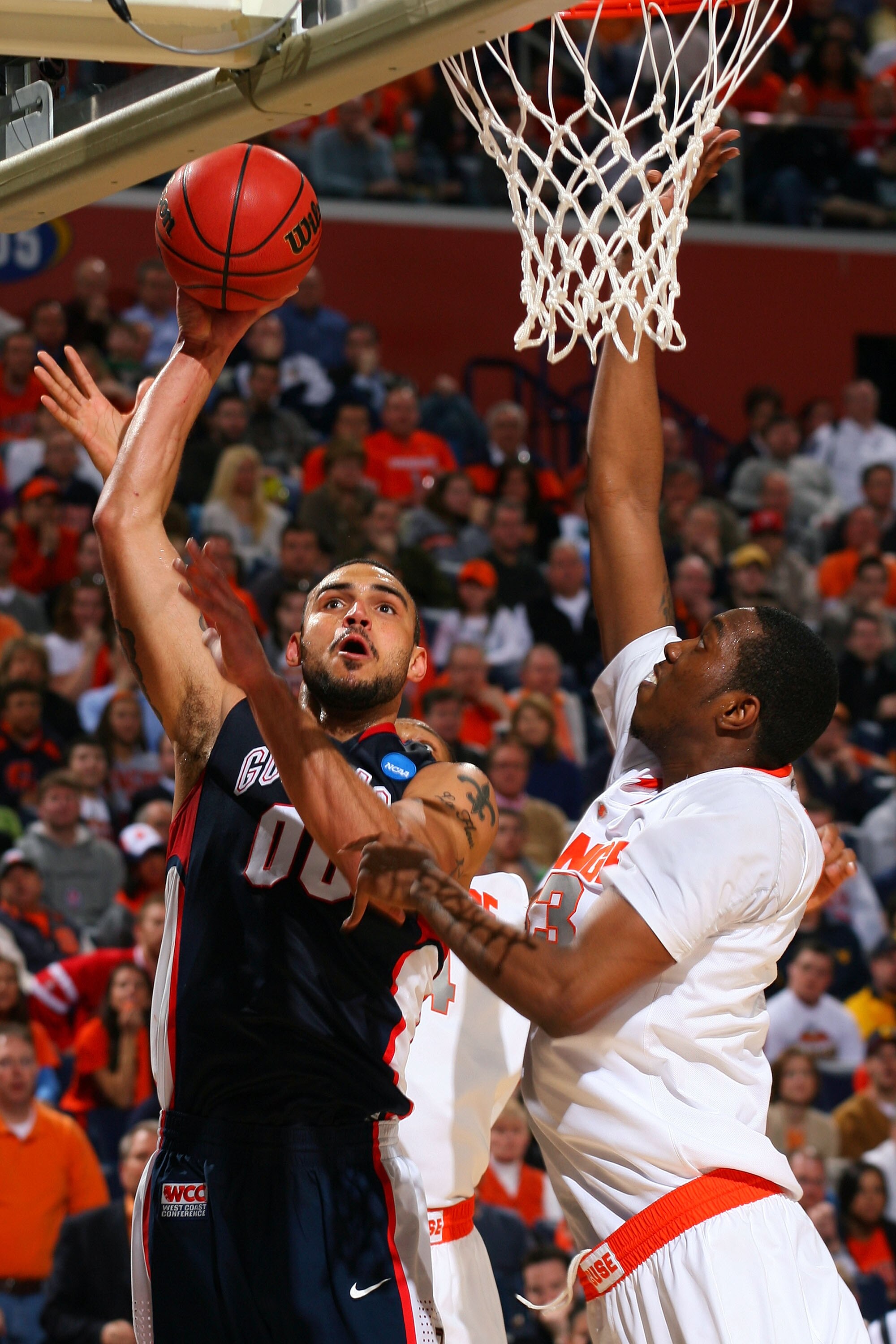 BUFFALO, NY - MARCH 21:  Robert Sacre #00 of the Gonzaga Bulldogs shoots over DaShonte Riley #33 of the Syracuse Orange during the second round of the 2010 NCAA men's basketball tournament at HSBC Arena at HSBC Arena on March 21, 2010 in Buffalo, New York
