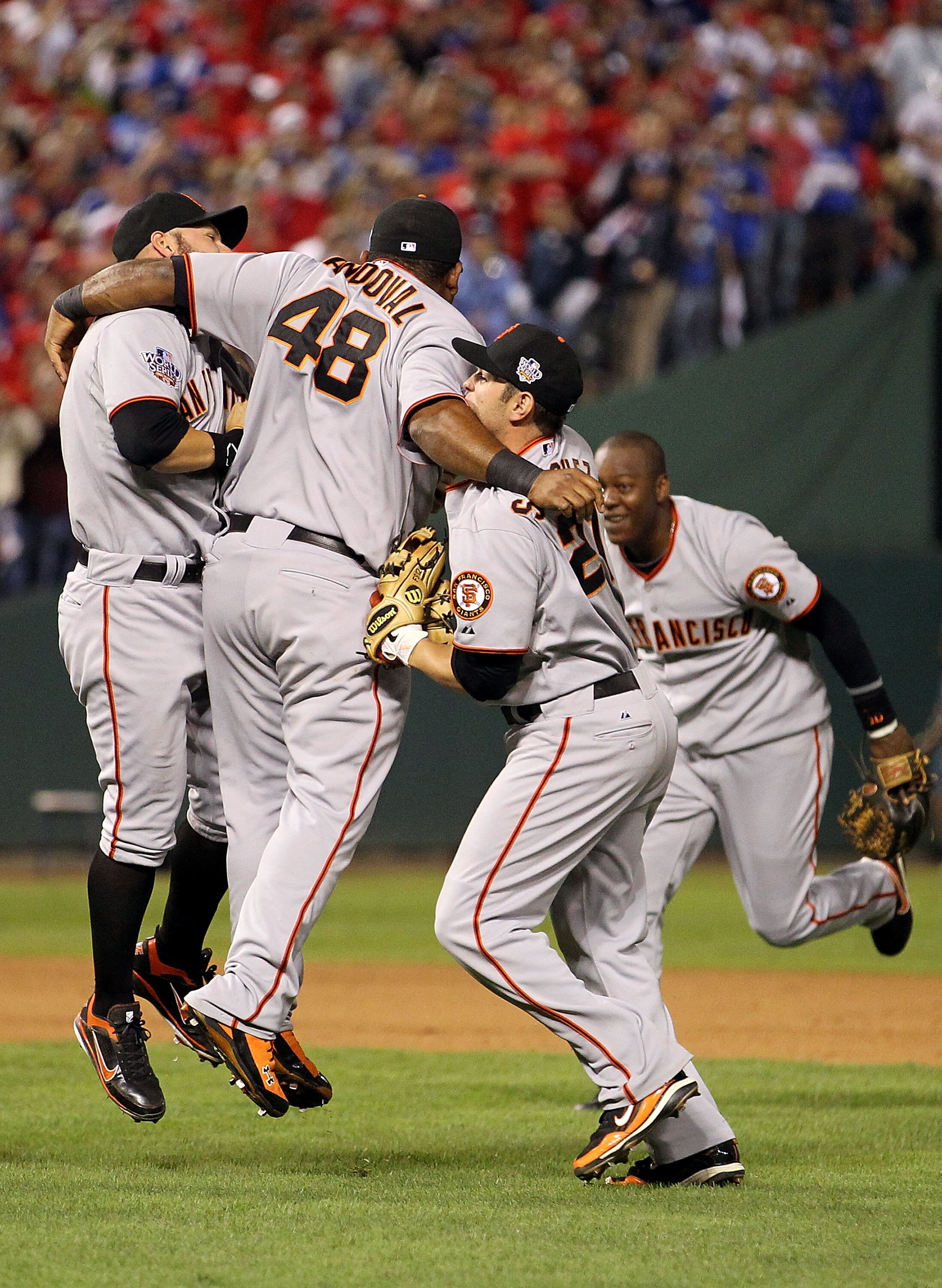 ARLINGTON, TX - NOVEMBER 01:  (L-R) Cody Ross #13, Pablo Sandoval #48, Freddy Sanchez #21 and Edgar Renteria #16 of the San Francisco Giants celebrate after they won 3-1 against the Texas Rangers in Game Five of the 2010 MLB World Series at Rangers Ballpa