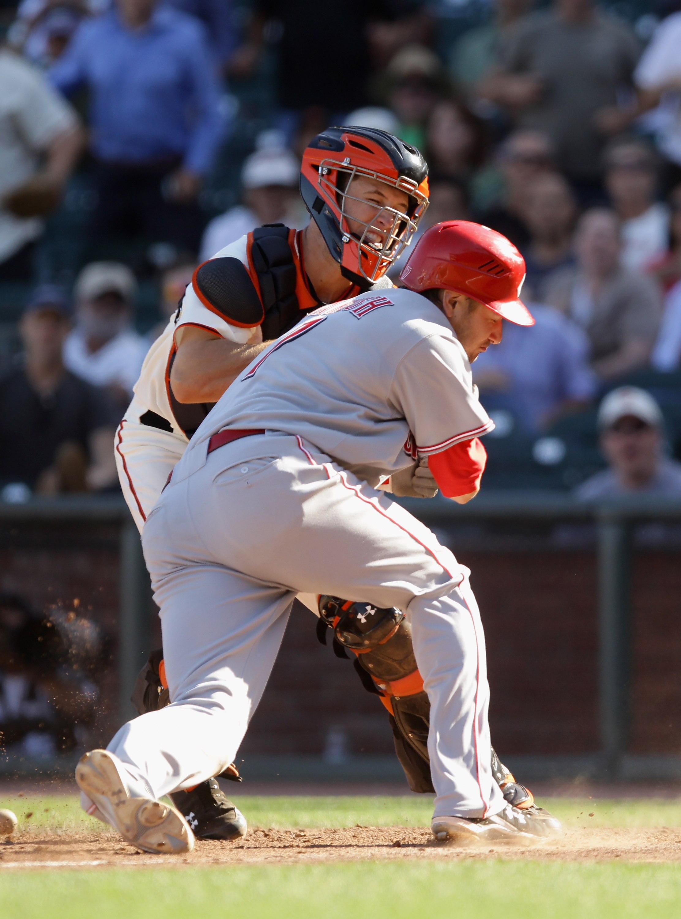 SAN FRANCISCO - AUGUST 25:  Buster Posey #28 of the San Francisco Giants tags out Paul Janish #7 of the Cincinnati Reds in the 12th inning at AT&T Park on August 25, 2010 in San Francisco, California.  (Photo by Ezra Shaw/Getty Images)