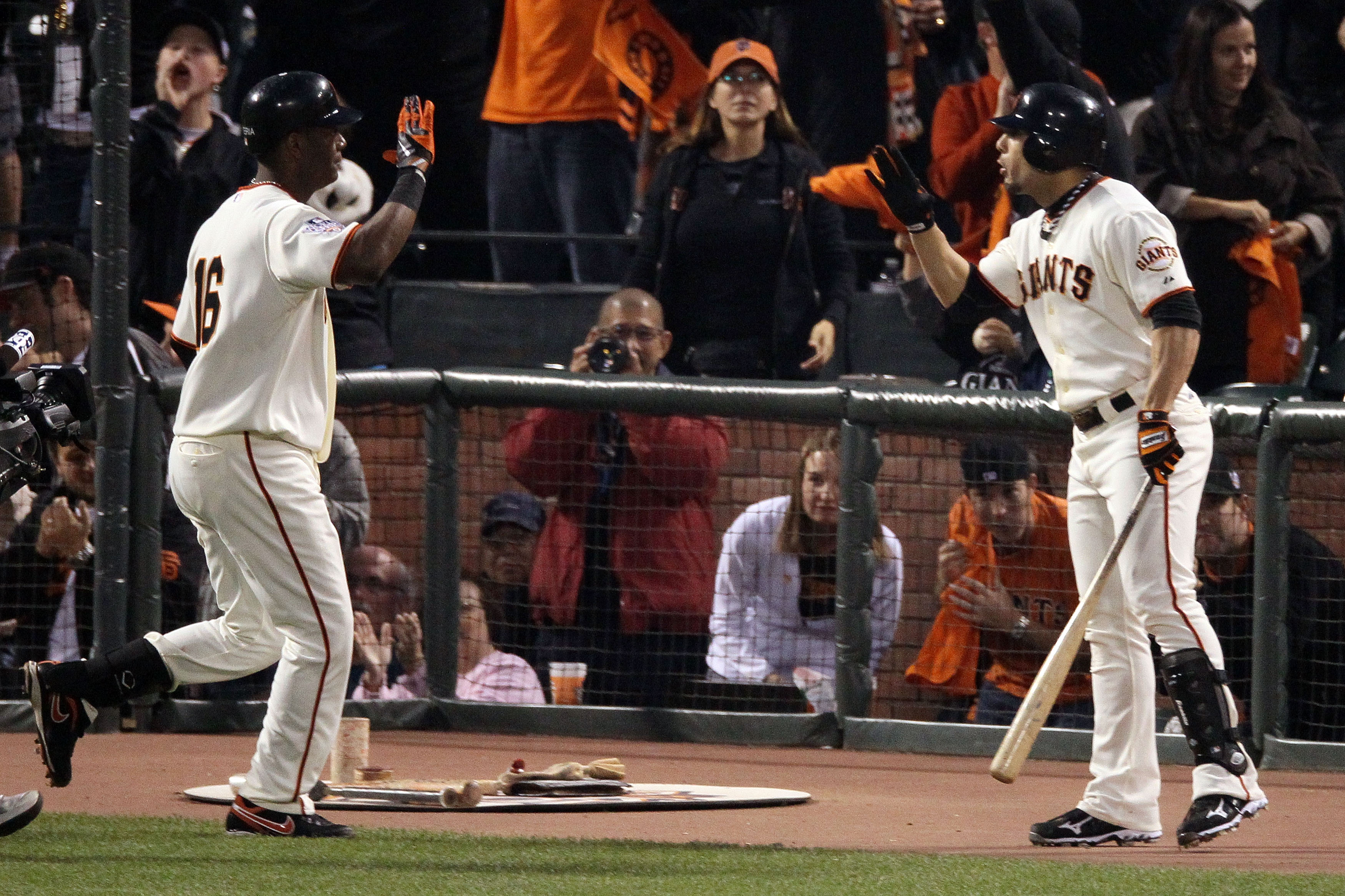 SAN FRANCISCO - OCTOBER 28:  (L-R) Edgar Renteria #16 of the San Francisco Giants is greeted by Andres Torres #56 after Renteria hits a fifth inning solo home run off of C.J. Wilson #36 of the Texas Rangers in Game Two of the 2010 MLB World Series at AT&T