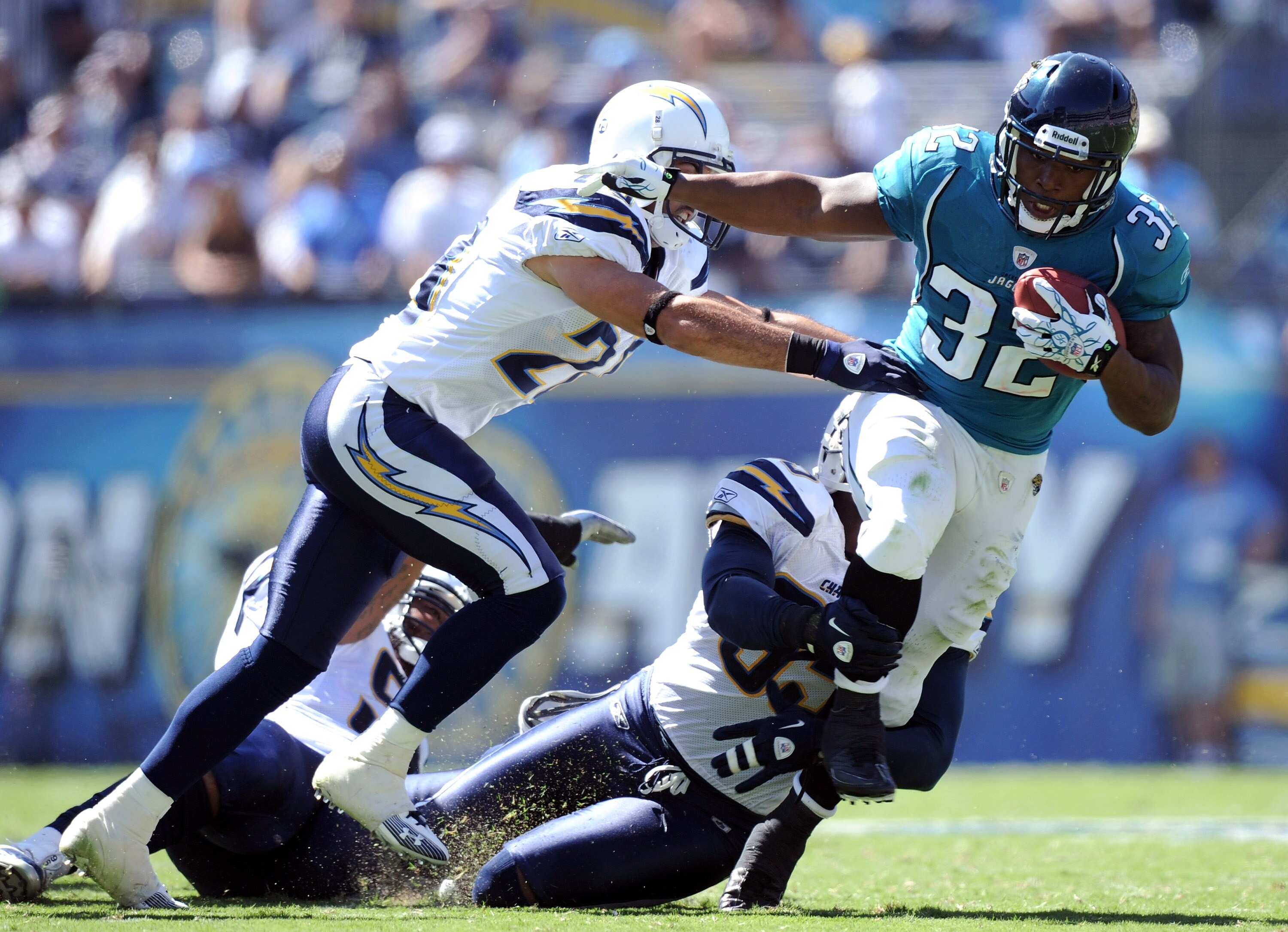 SAN DIEGO - SEPTEMBER 19:  Maurice Jones-Drew #32 of the Jacksonville Jaguars is tackled by Steve Gregory #28 and Shaun Phillips #95 of the San Diego Chargers during the second quarter at Qualcomm Stadium on September 19, 2010 in San Diego, California.  (