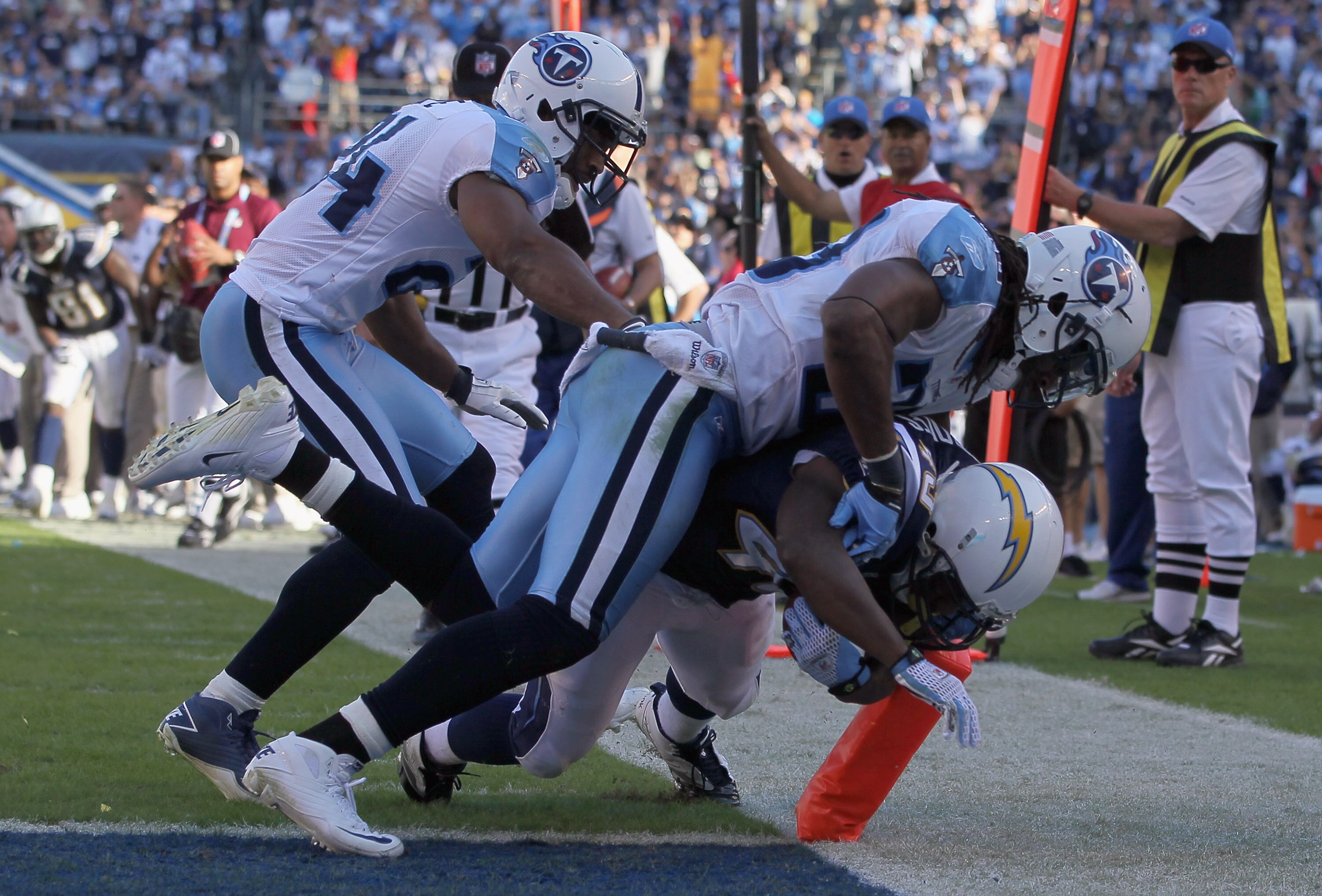 SAN DIEGO - OCTOBER 31:  Running back Darren Sproles #43 of the San Diego Chargers scores a touchdown while being tackled by Michael Griffin #33 and Chris Hope #24 of the Tennessee Titans in the fourth quarter at Qualcomm Stadium on October 31, 2010 in Sa