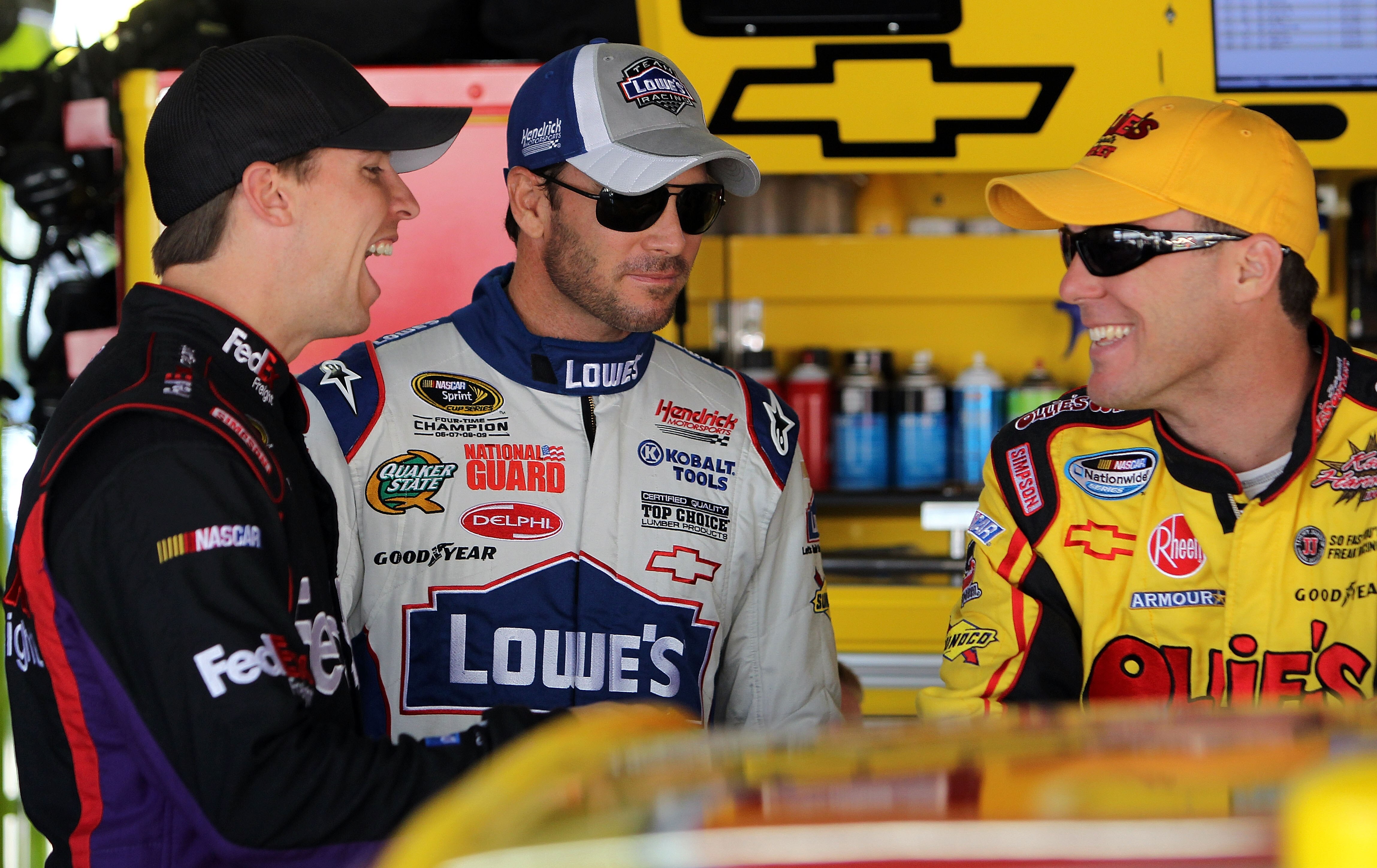 DOVER, DE - MAY 15:  (L-R) Denny Hamlin, driver of the #11 FedEx Freight Toyota, Jimmie Johnson, driver of the #48 Lowe's Chevrolet, and Kevin Harvick, driver of the #29 Shell/Pennzoil Chevrolet, talk in the garage prior to practice for the NASCAR Sprint