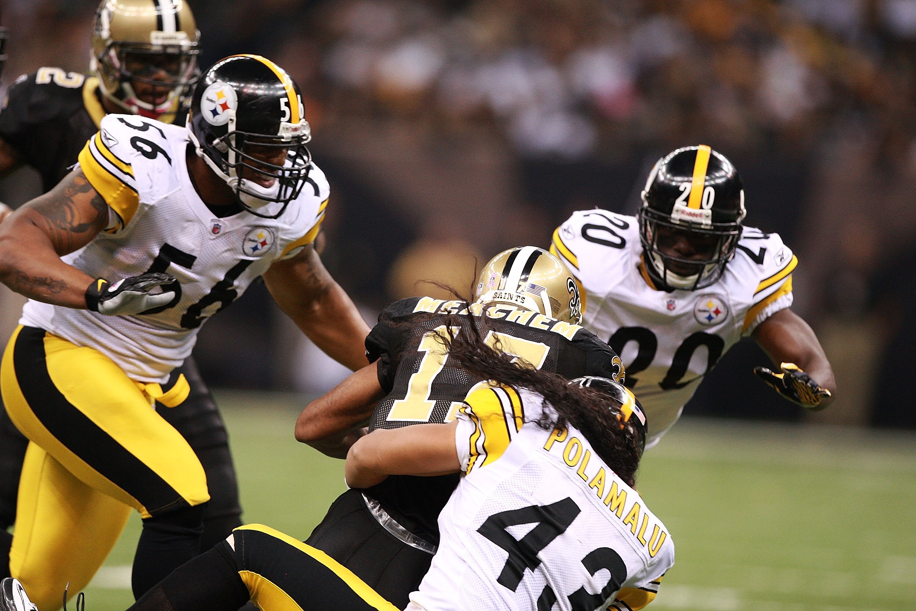 NEW ORLEANS - OCTOBER 31:  LaMarr Woodley #56 and Bryant McFadden #20 pursue while Troy Polamalu #43 of the Pittsburgh Steelers tackles Robert Meachem #17 of the New Orleans Saints at Louisiana Superdome on October 31, 2010 in New Orleans, Louisiana.  The