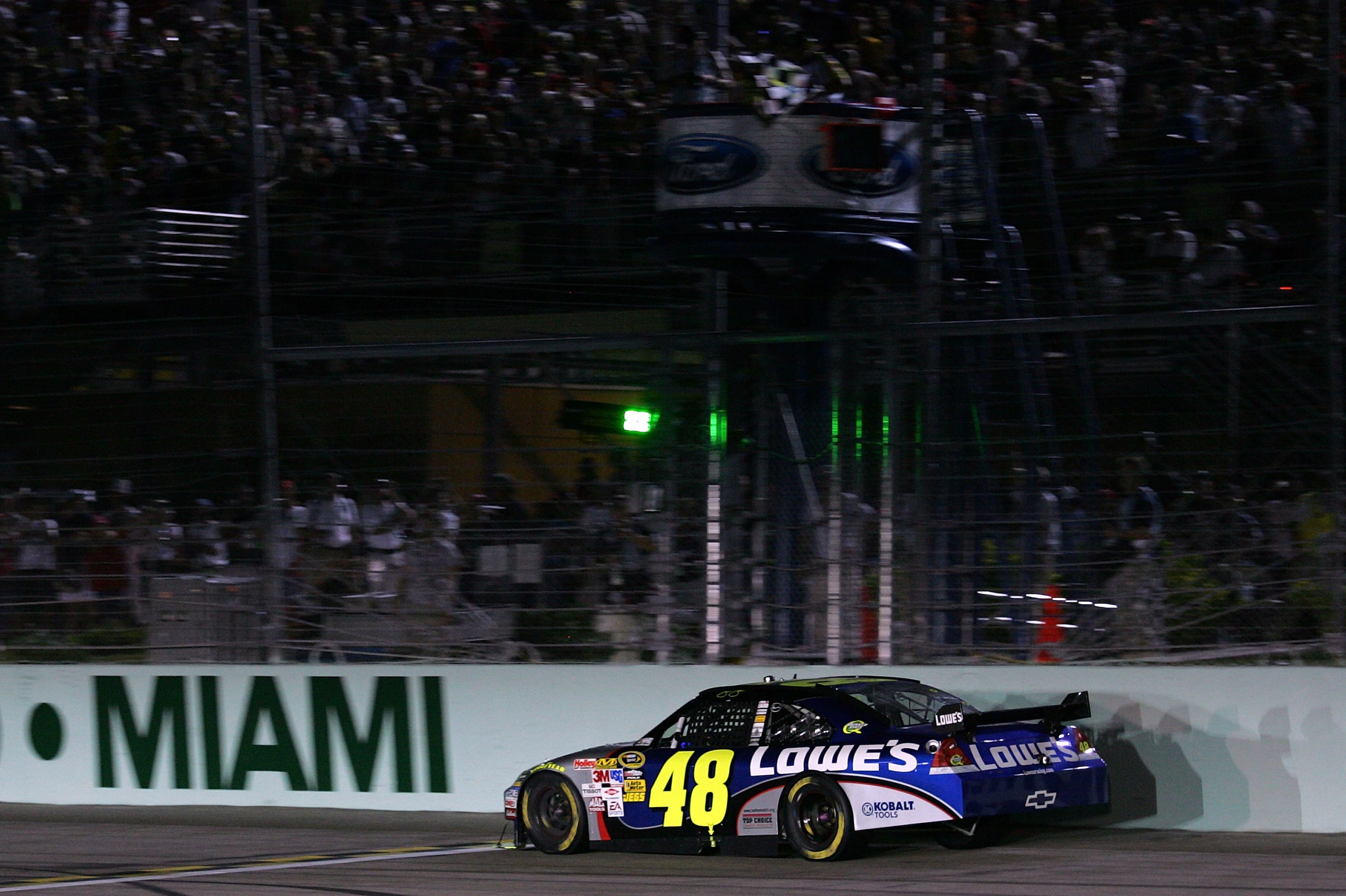 HOMESTEAD, FL - NOVEMBER 22:  Jimmie Johnson, driver of the #48 Lowe's Chevrolet, crosses the finish line in fifth place in the NASCAR Sprint Cup Series Ford 400 at Homestead-Miami Speedway on November 22, 2009 in Homestead, Florida. Johnson becomes the f