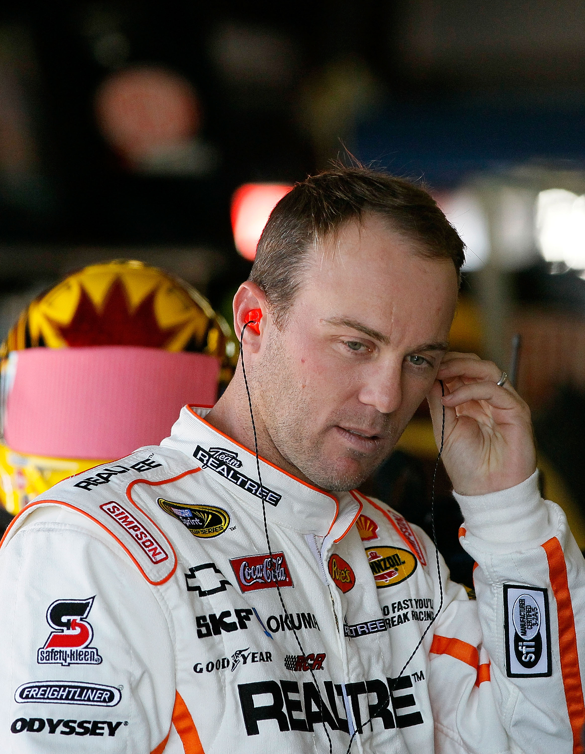 TALLADEGA, AL - OCTOBER 29:  Kevin Harvick, driver of the #29 Realtree/Shell/Pennzoil Chevrolet, stands in the garage during practice for the NASCAR Sprint Cup Series AMP Energy Juice 500 at Talladega Superspeedway on October 29, 2010 in Talladega, Alabam