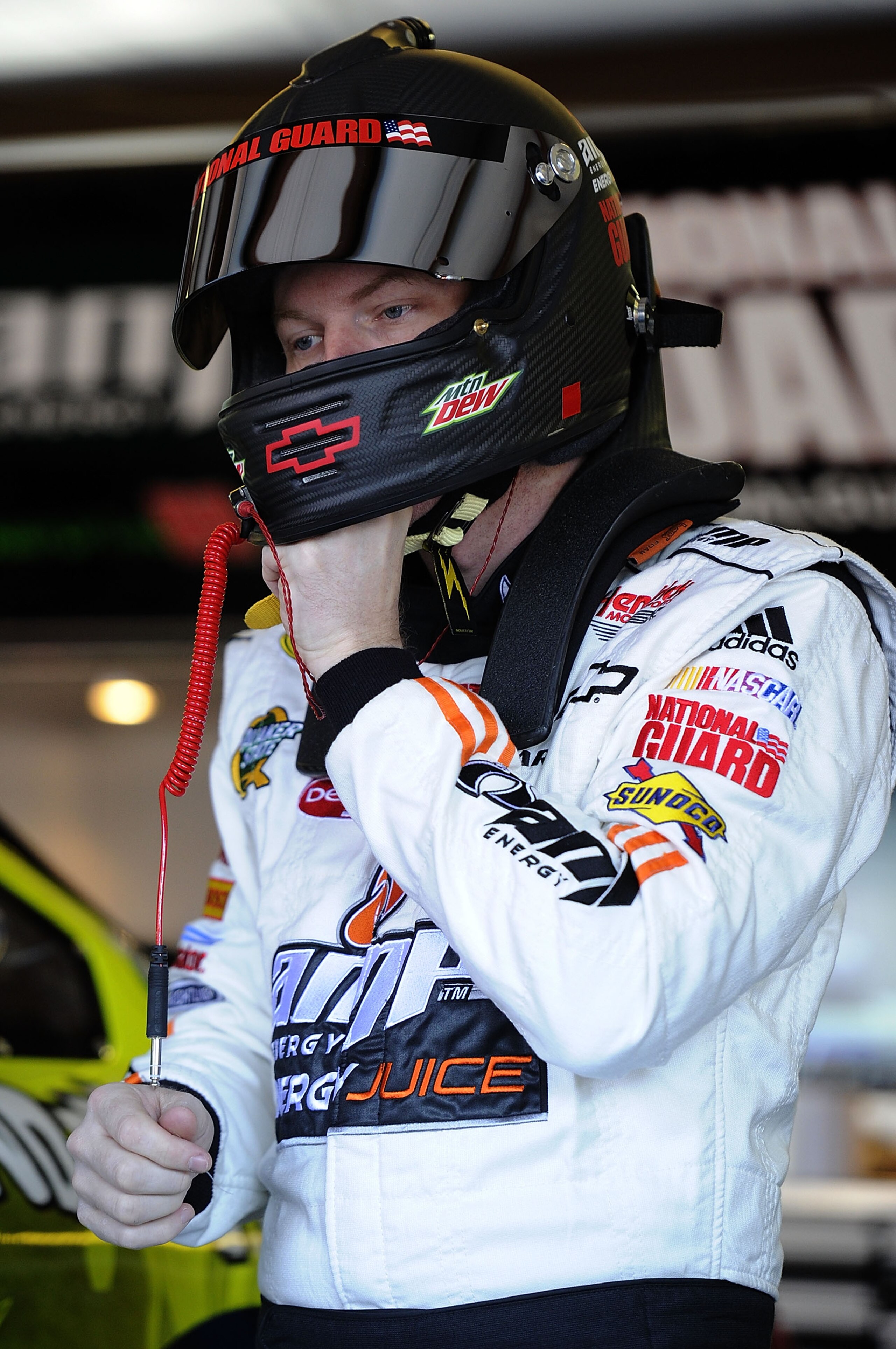 TALLADEGA, AL - OCTOBER 29:  Dale Earnhardt Jr., driver of the #88 AMP Energy Juice/National Guard Chevrolet, stands in the garage during practice for the NASCAR Sprint Cup Series AMP Energy Juice 500 at Talladega Superspeedway on October 29, 2010 in Tall