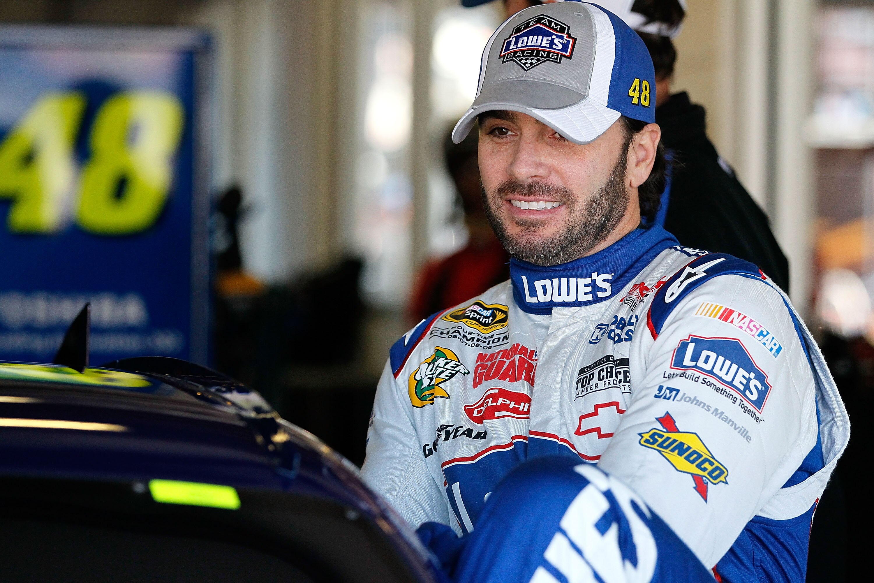 TALLADEGA, AL - OCTOBER 29:  Jimmie Johnson, driver of the #48 Lowe's Chevrolet, climbs in his car in the garage during practice for the NASCAR Sprint Cup Series AMP Energy Juice 500 at Talladega Superspeedway on October 29, 2010 in Talladega, Alabama.  (