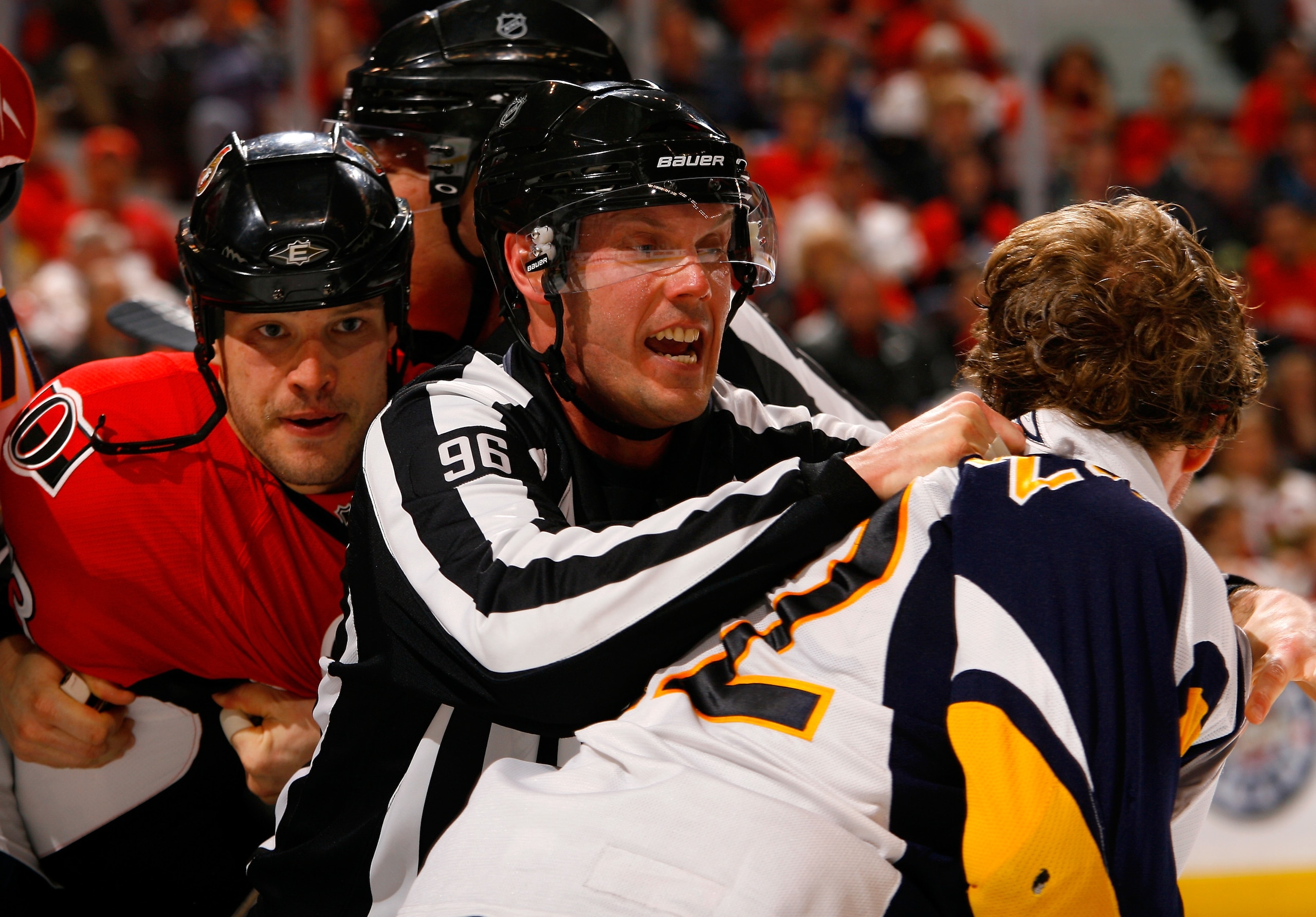 OTTAWA, ON - APRIL 10:  Linesman David Brisebois (96) gets in between Jarkko Ruutu #73 of the Ottawa Senators and Adam Mair #22 of the Buffalo Sabres while trying to break up a fight in a game at Scotiabank Place on April 10, 2010 in Ottawa, Canada. The B