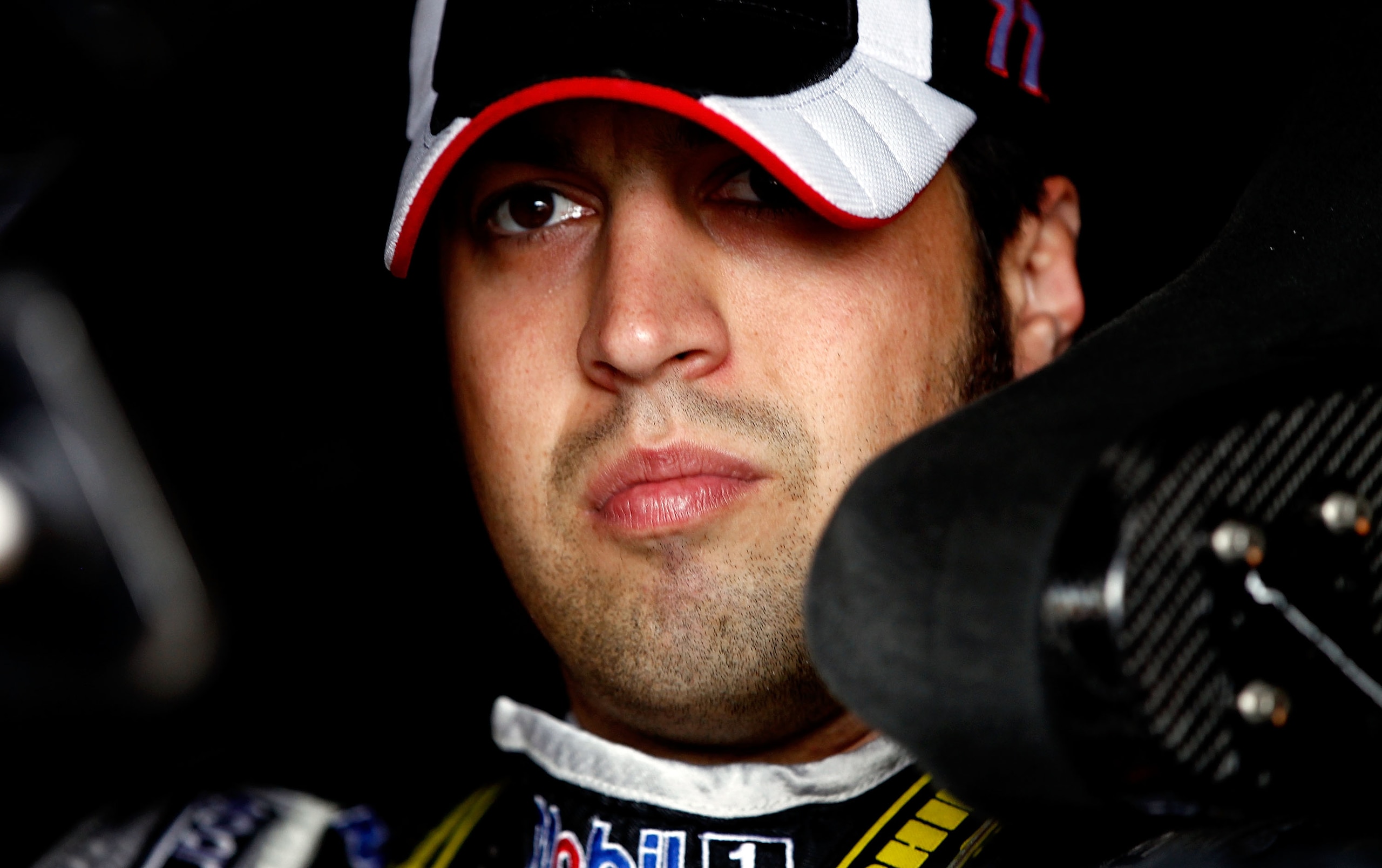 DOVER, DE - SEPTEMBER 25:  Sam Hornish Jr., driver of the #77 Mobil 1 Dodge, climbs in his car during practice for the NASCAR Sprint Cup Series AAA 400 at Dover International Speedway on September 25, 2010 in Dover, Delaware.  (Photo by Jeff Zelevansky/Ge