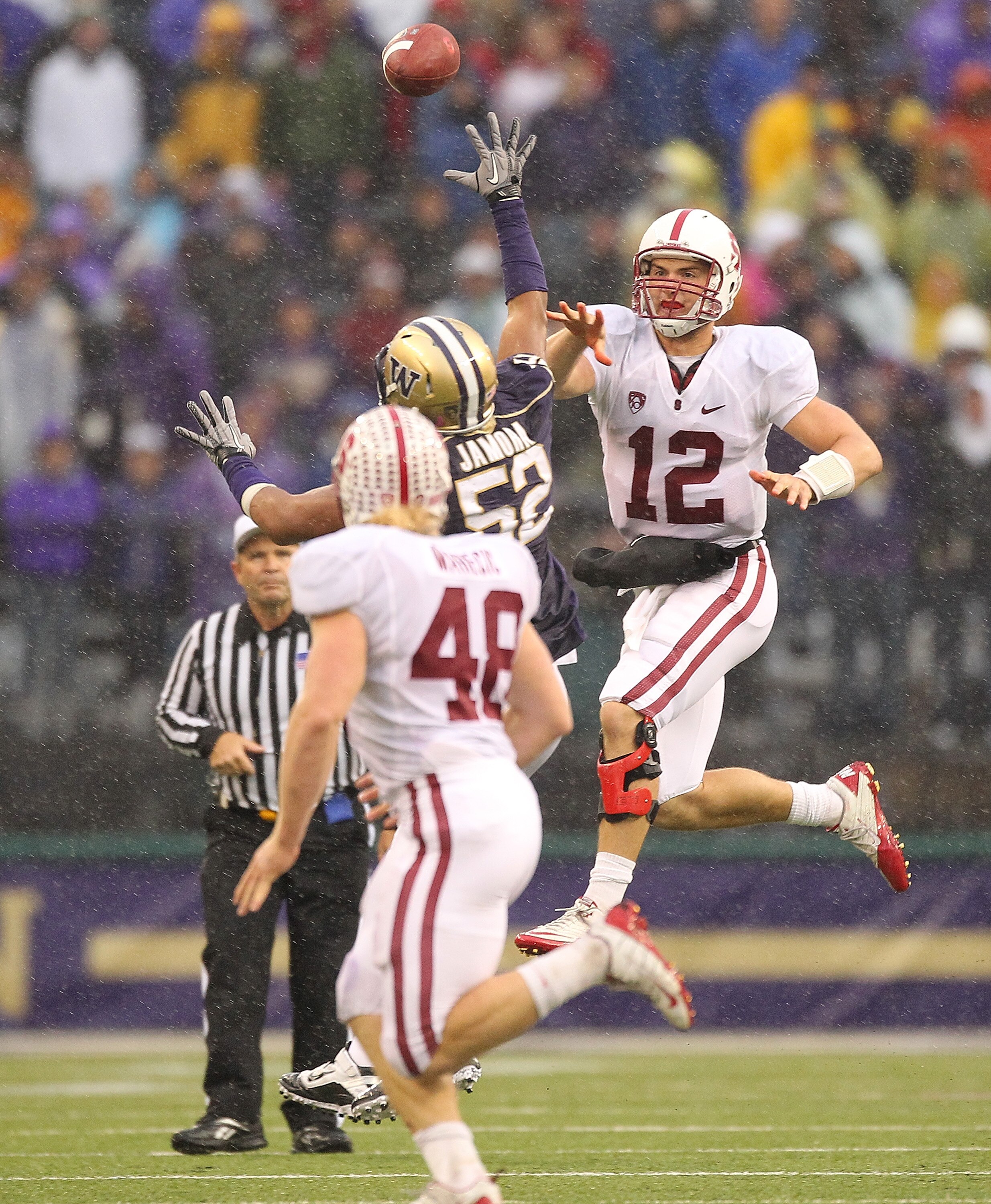 SEATTLE - OCTOBER 30:  Quarterback Andrew Luck #12 of the Stanford Cardinal passes against Hau'oli Jamora #52 of the Washington Huskies on October 30, 2010 at Husky Stadium in Seattle, Washington. Stanford defeated Washington 41-0. (Photo by Otto Greule J