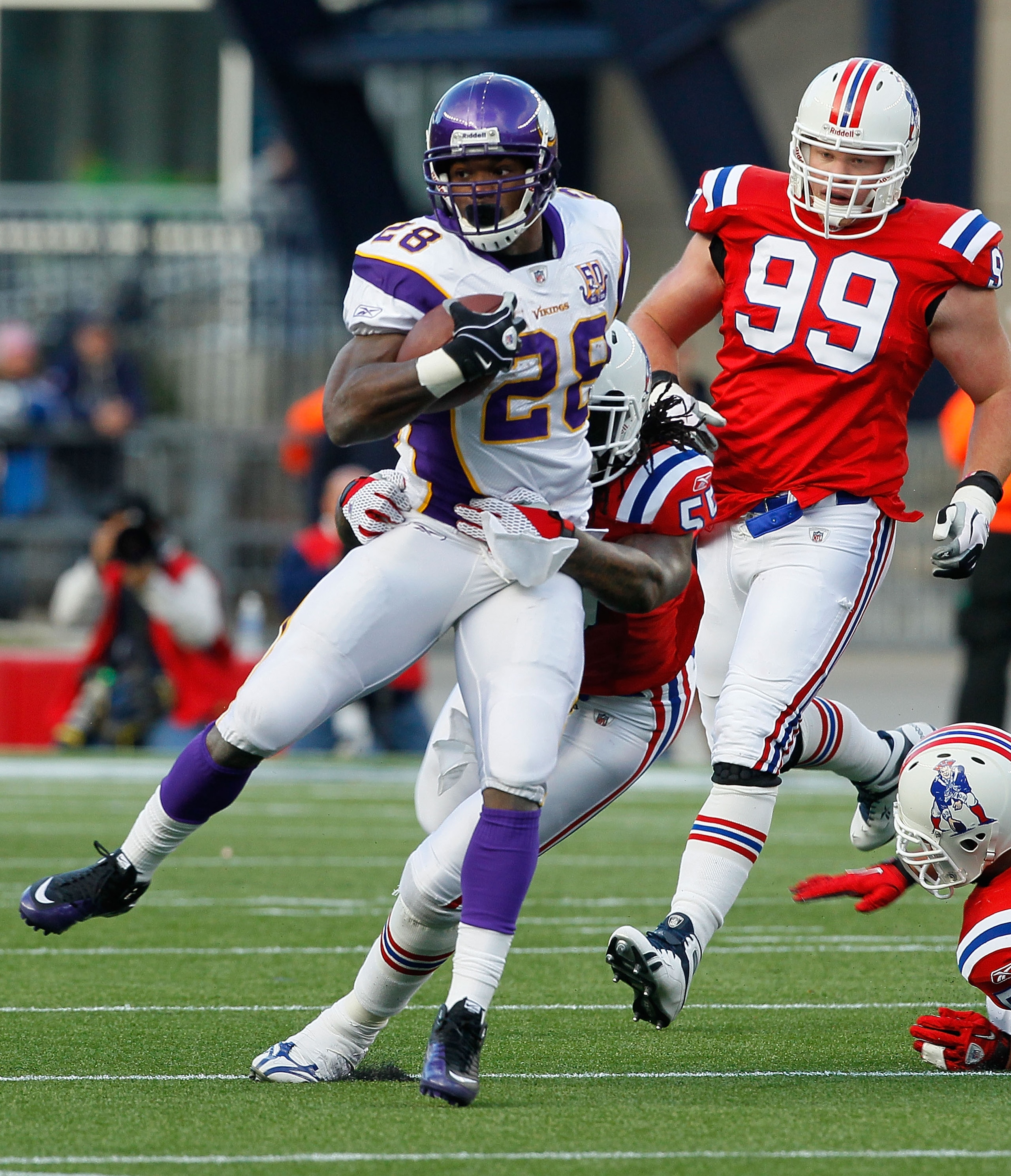 FOXBORO, MA - OCTOBER 31:  Adrian Peterson #28 the Minnesota Vikings is stopped against the New England Patriots at Gillette Stadium on October 31, 2010 in Foxboro, Massachusetts. (Photo by Jim Rogash/Getty Images)