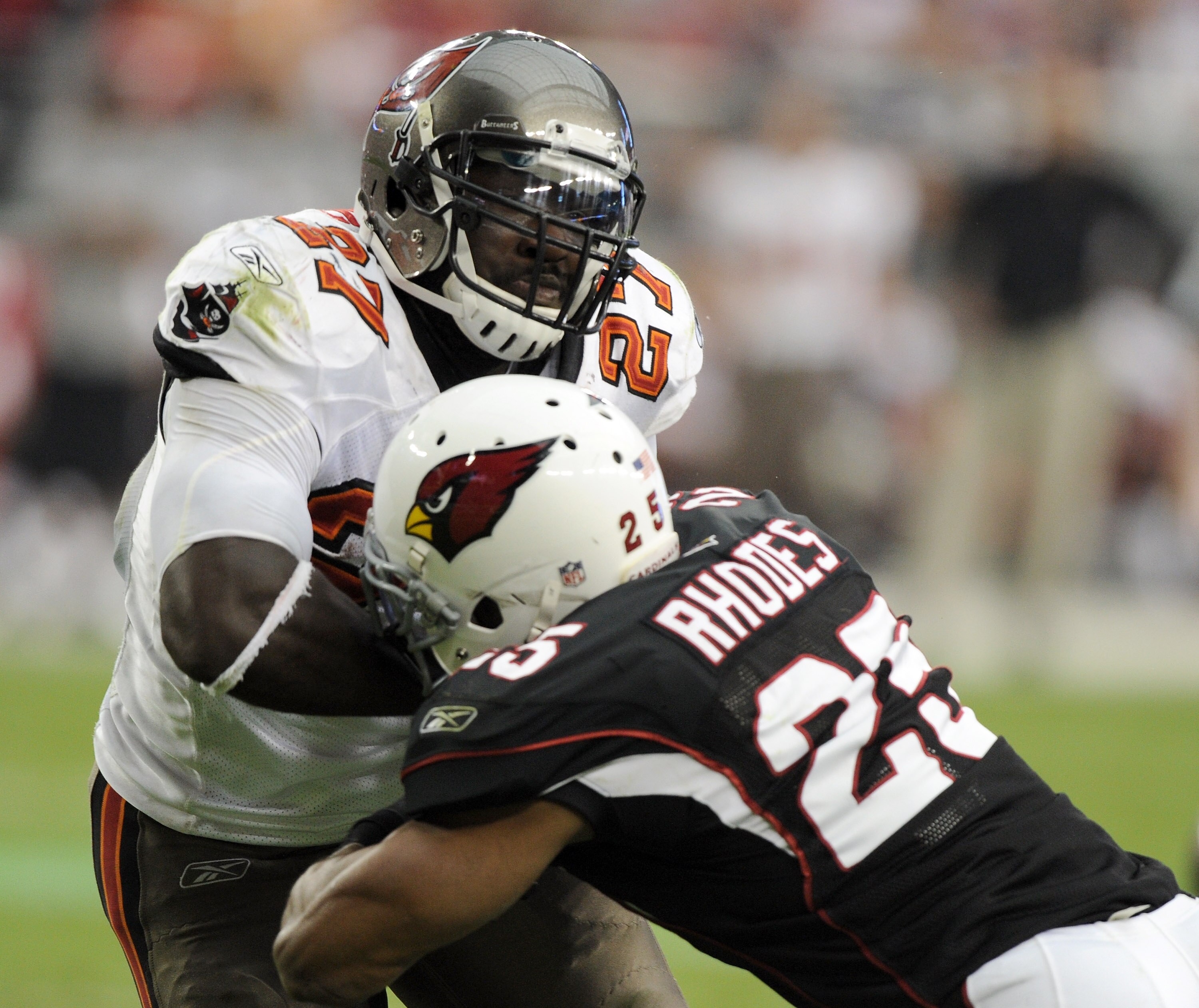 GLENDALE, AZ - OCTOBER 31:  LeGarrette Blount #27 of the Tampa Bay Buccaneers bounces off the tackle of Kerry Rhodes #25 of the Arizona Cardinals for a 31-14 lead during the third quarter at University of Phoenix Stadium on October 31, 2010 in Glendale, A