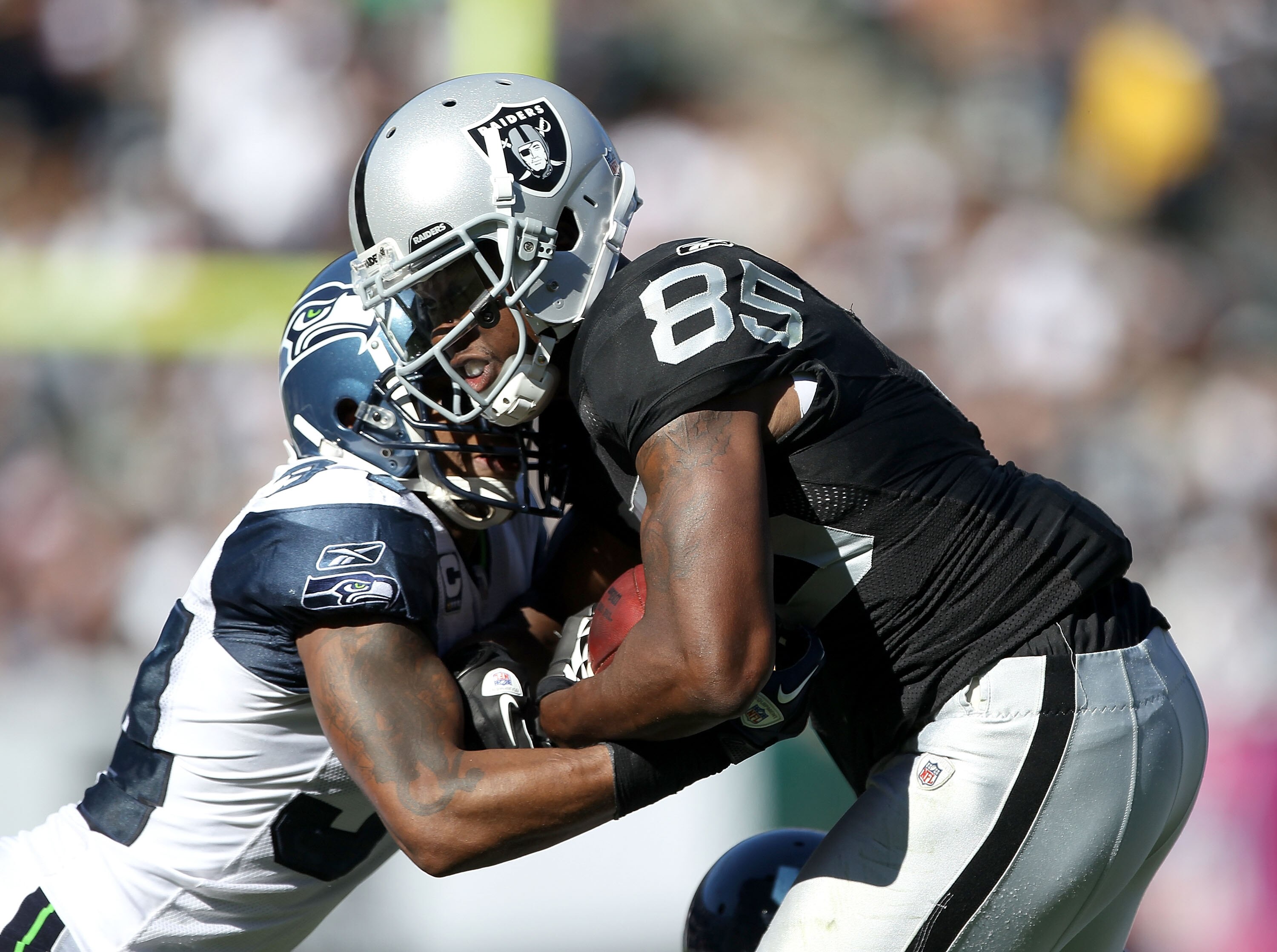OAKLAND, CA - OCTOBER 31:  Darrius Heyward-Bey #85 of the Oakland Raiders is tackled by Roy Lewis #34 of the Seattle Seahawks at Oakland-Alameda County Coliseum on October 31, 2010 in Oakland, California.  (Photo by Ezra Shaw/Getty Images)