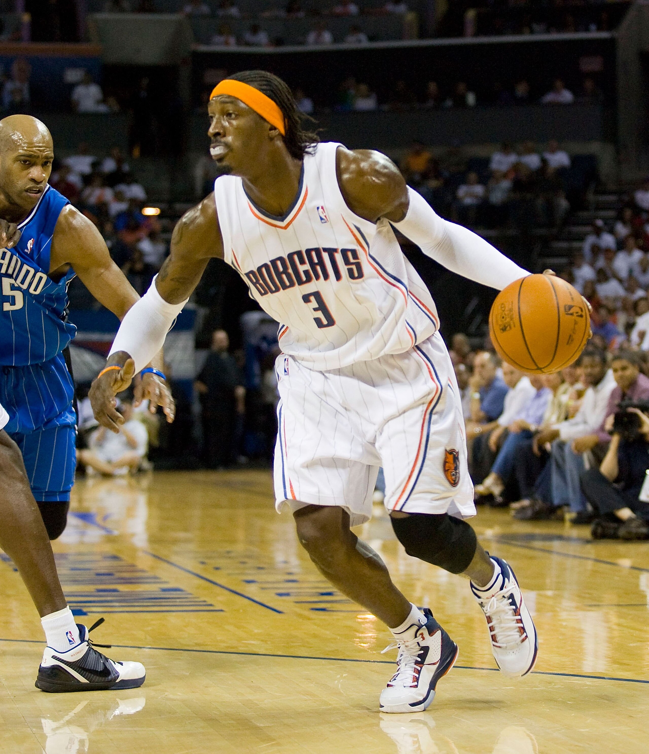 CHARLOTTE, NC - APRIL 26: Gerald Wallace #3 of the Charlotte Bobcats dribbles away from Vince Carter #15 of the Orlando Magic at Time Warner Cable Arena on April 26, 2010 in Charlotte, North Carolina.  The Magic defeated the Bobcats 99-90 to complete the 