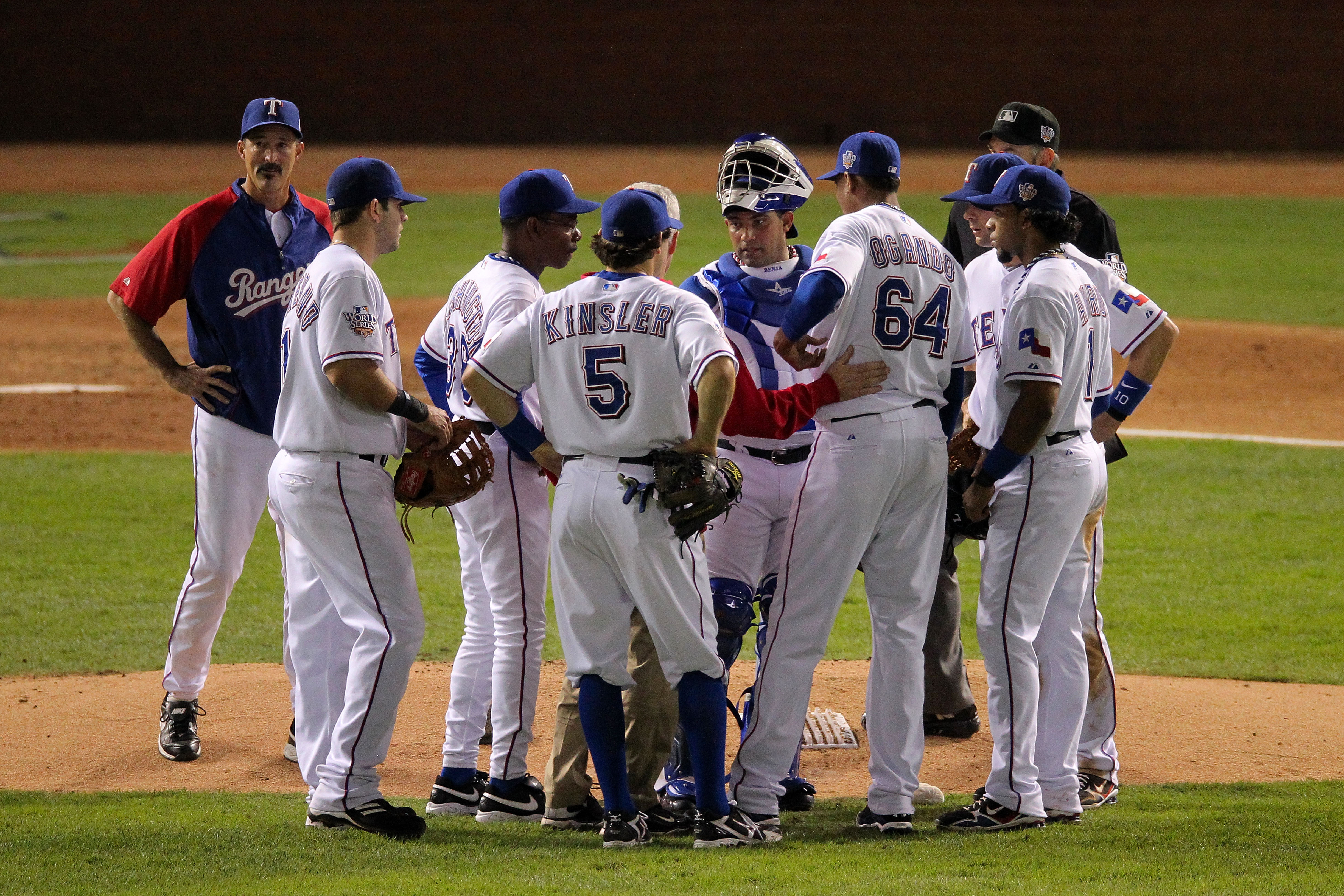 ARLINGTON, TX - OCTOBER 31:  Relief pitcher Alexi Ogando #64 of the Texas Rangers points to his left side before he leaves in the top of the sixth inning against the San Francisco Giants in Game Four of the 2010 MLB World Series at Rangers Ballpark in Arl