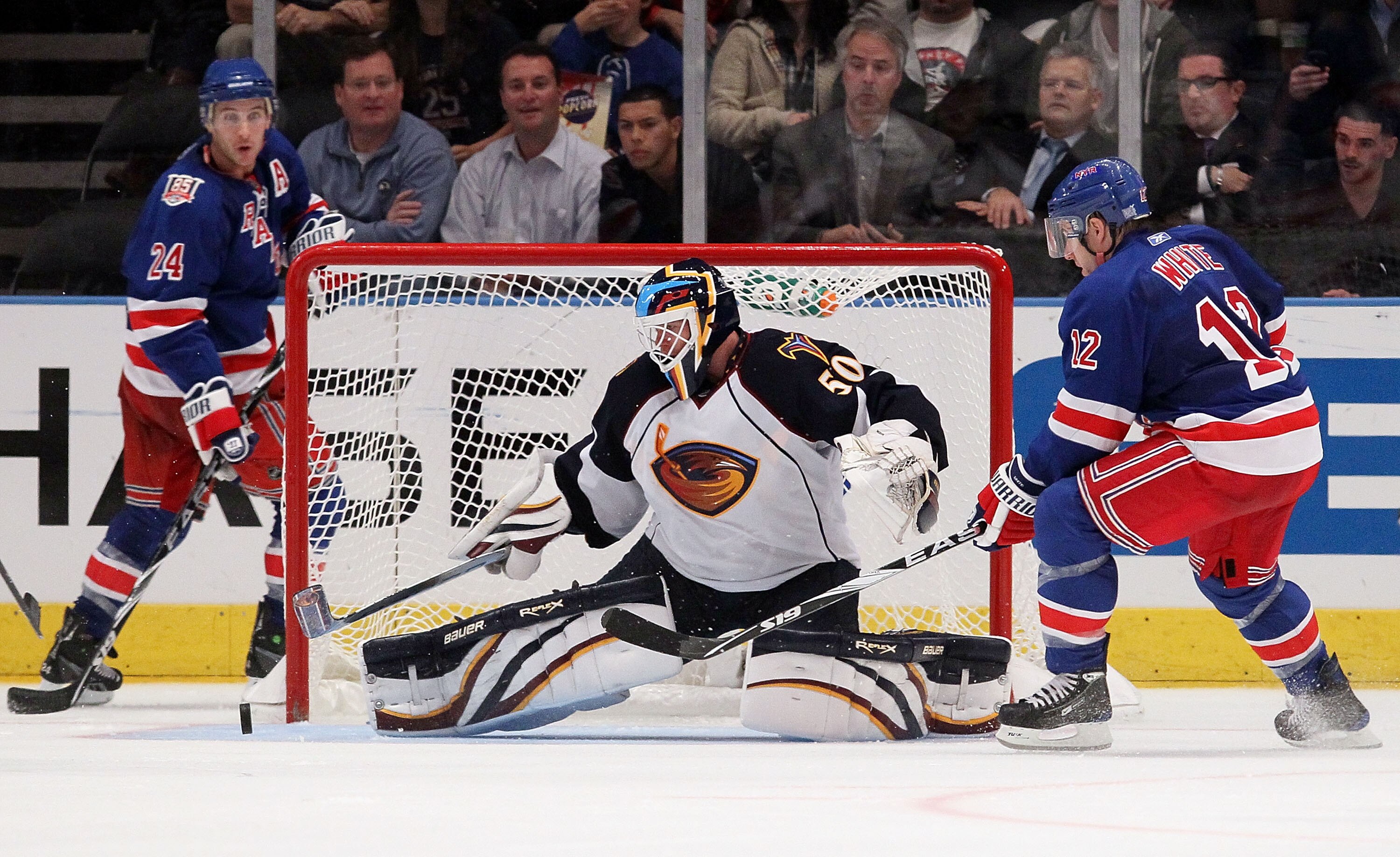 NEW YORK - OCTOBER 27:  Chris Mason #50 of the Atlanta Thrashers makes a save as Todd White #12 and Ryan Callahan #24 of the New York Rangers look for the rebound on October 27, 2010 at Madison Square Garden in New York City.  (Photo by Jim McIsaac/Getty