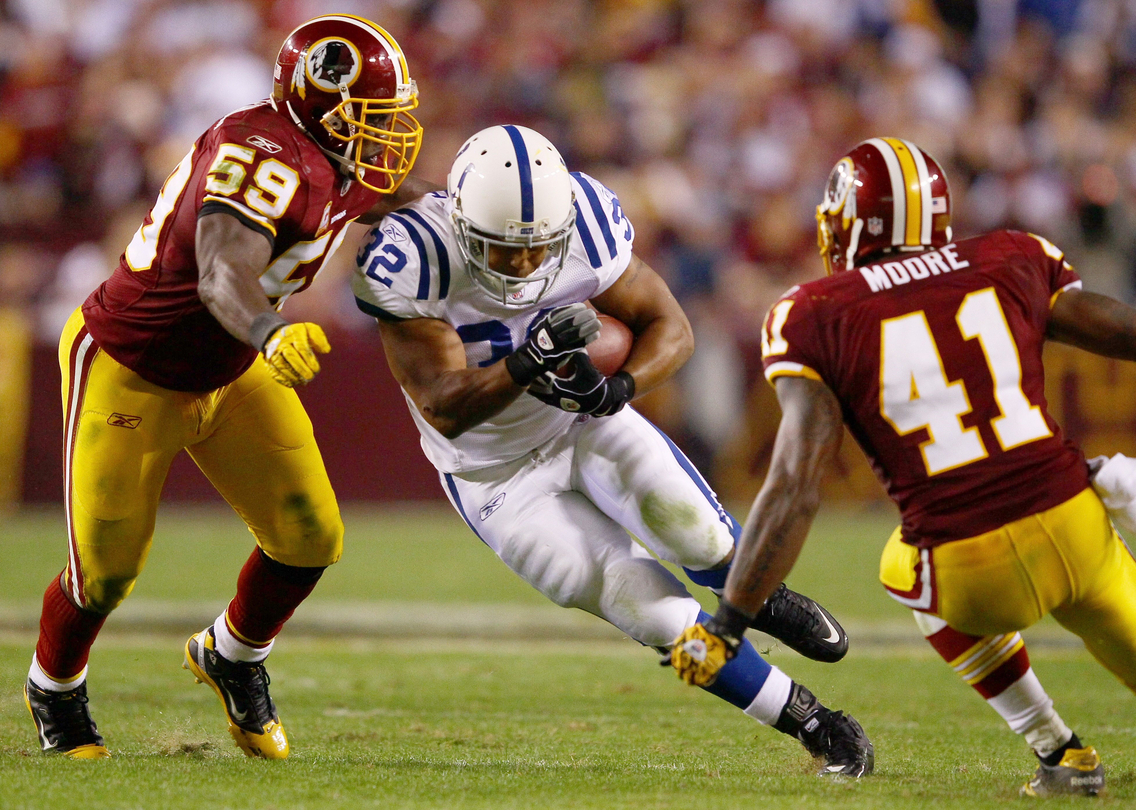 LANDOVER, MD - OCTOBER 17: Running back Mike Hart #32 of the Indianapolis Colts is tackled by London Fletcher #59 and Kareem Moore #41 of the Washington Redskin at FedExField on October 17, 2010 in Landover, Maryland. The Colts won the game 27-24. (Phot LANDOVER, MD - OCTOBER 17: Running back Mike Hart #32 of the Indianapolis Colts is tackled by London Fletcher #59 and Kareem Moore #41 of the Washington Redskin at FedExField on October 17, 2010 in Landover, Maryland. The Colts won the game 27-24. (Phot