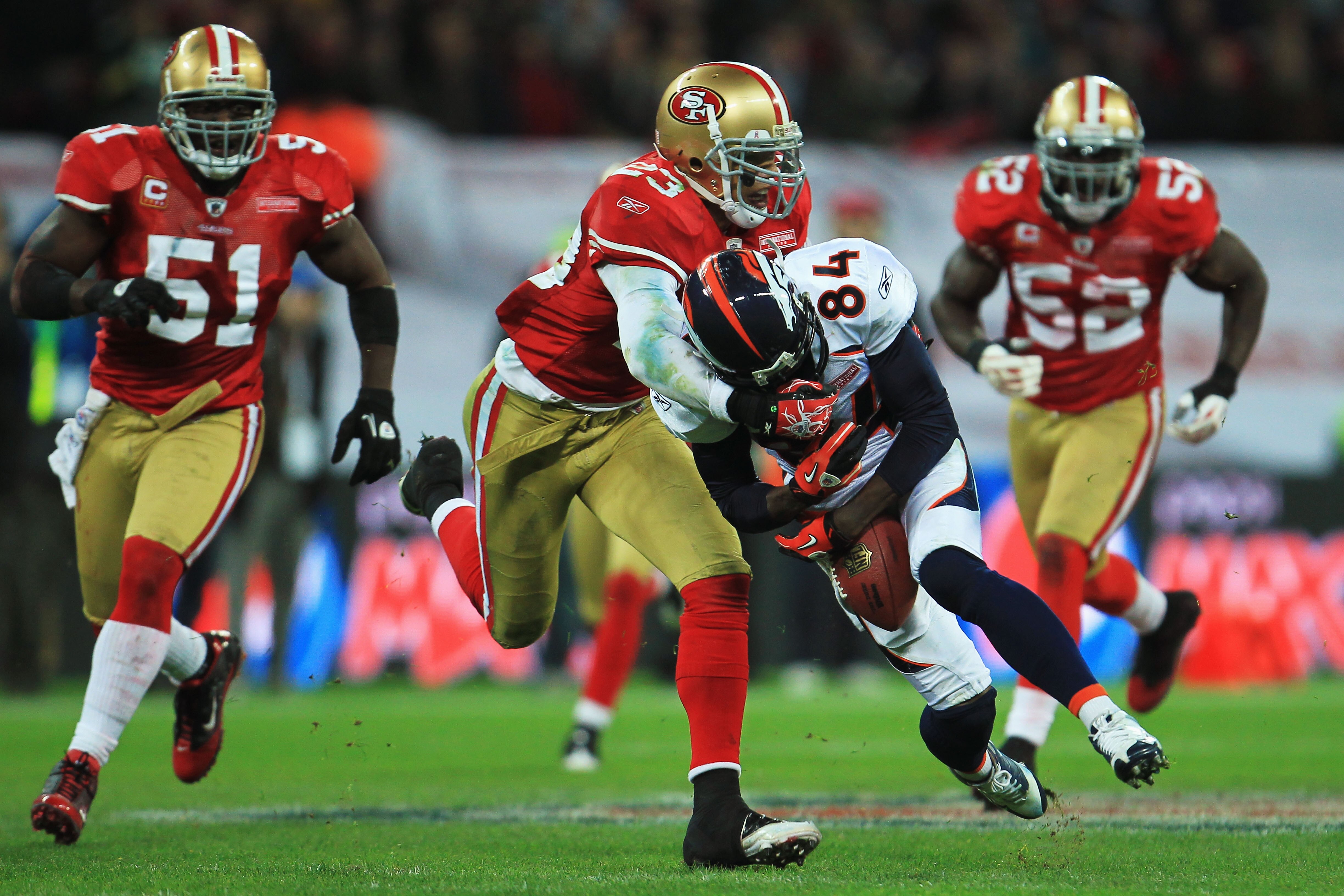 LONDON, ENGLAND - OCTOBER 31:  Brandon Lloyd #84 of Denver Broncos is tackled by Taylor Mays #23 of San Francisco 49ers during the NFL International Series match between Denver Broncos and San Francisco 49ers at Wembley Stadium on October 31, 2010 in Lond